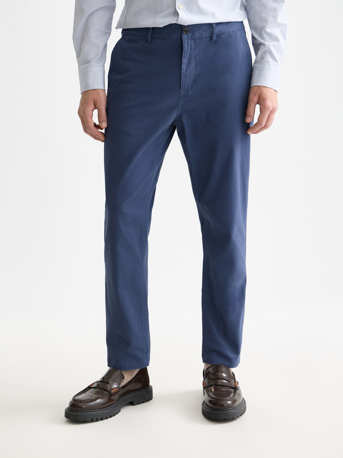 Drift tapered chinos by Scotch & Soda showing slim-fit pants in a neutral color with classic pocket details.