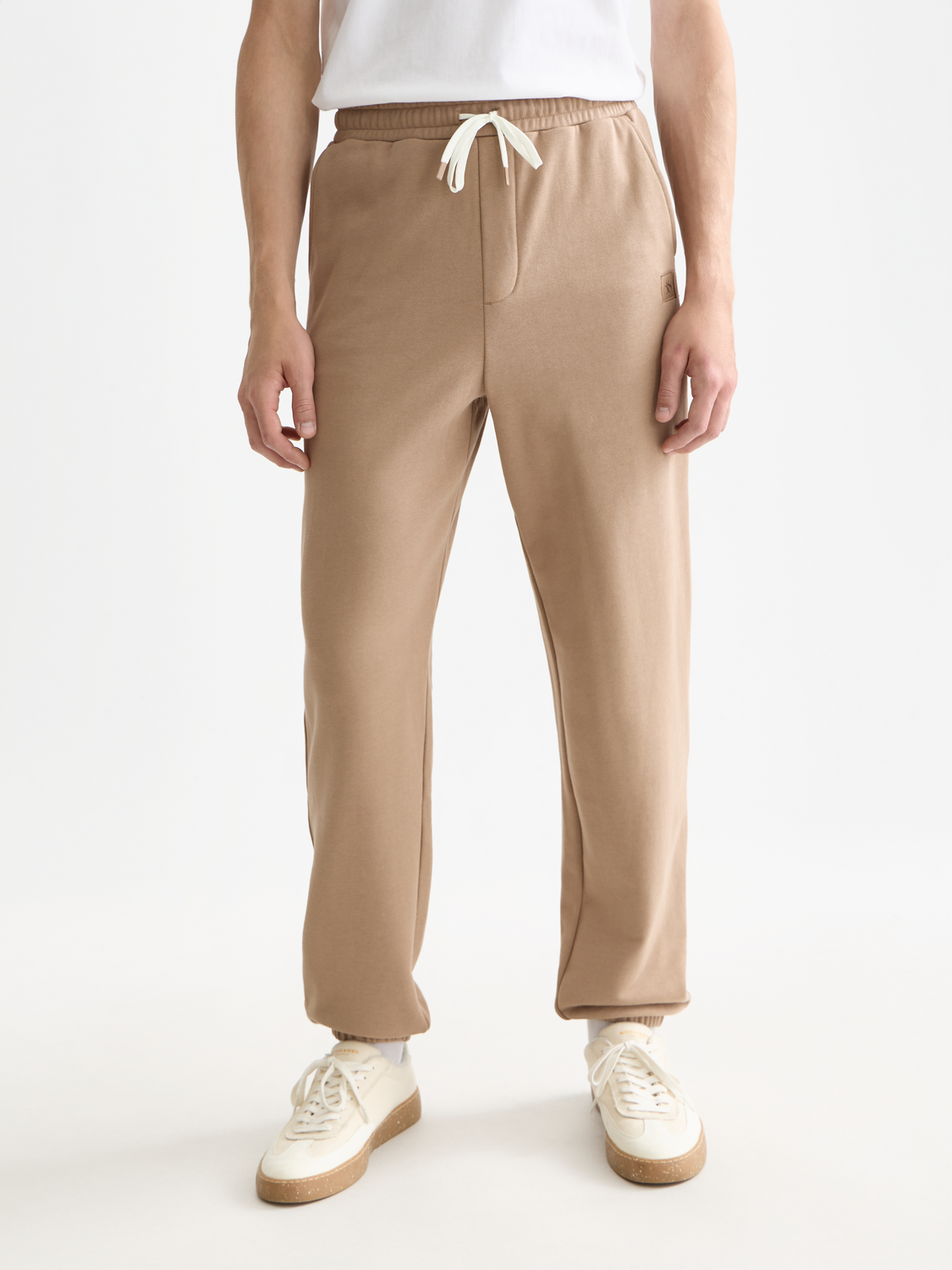 Scotch & Soda logo badge sweatpants featuring a relaxed fit and branded logo patch on the front, casual comfortable style.