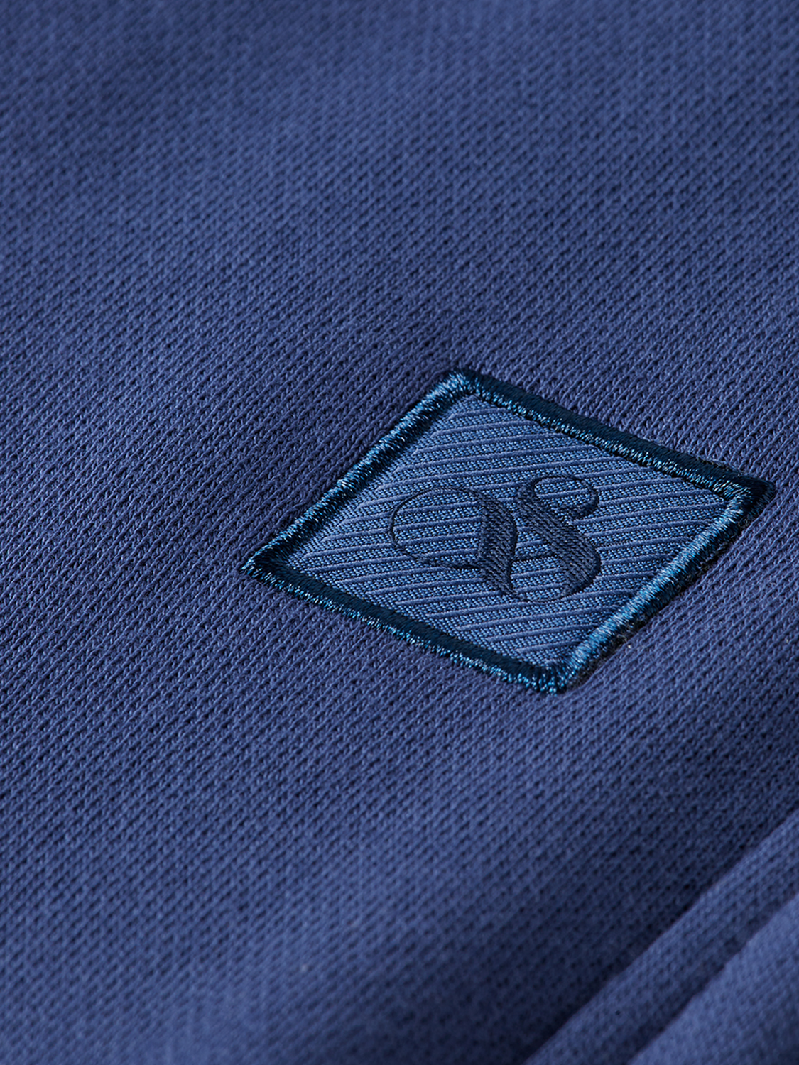Black sweatpants with a logo badge from Scotch & Soda, featuring a relaxed fit and comfortable elastic waistband.