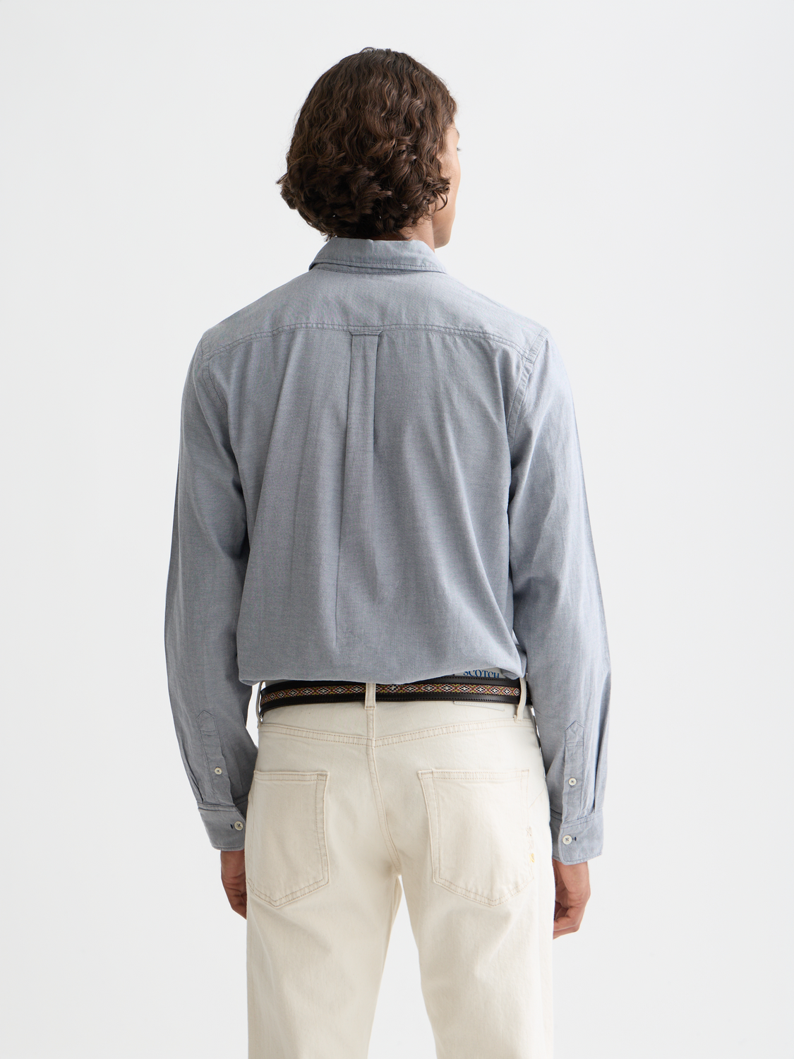 Long sleeve Oxford shirt by Scotch & Soda, navy blue with button-down collar and chest pocket, displayed on a model's back.