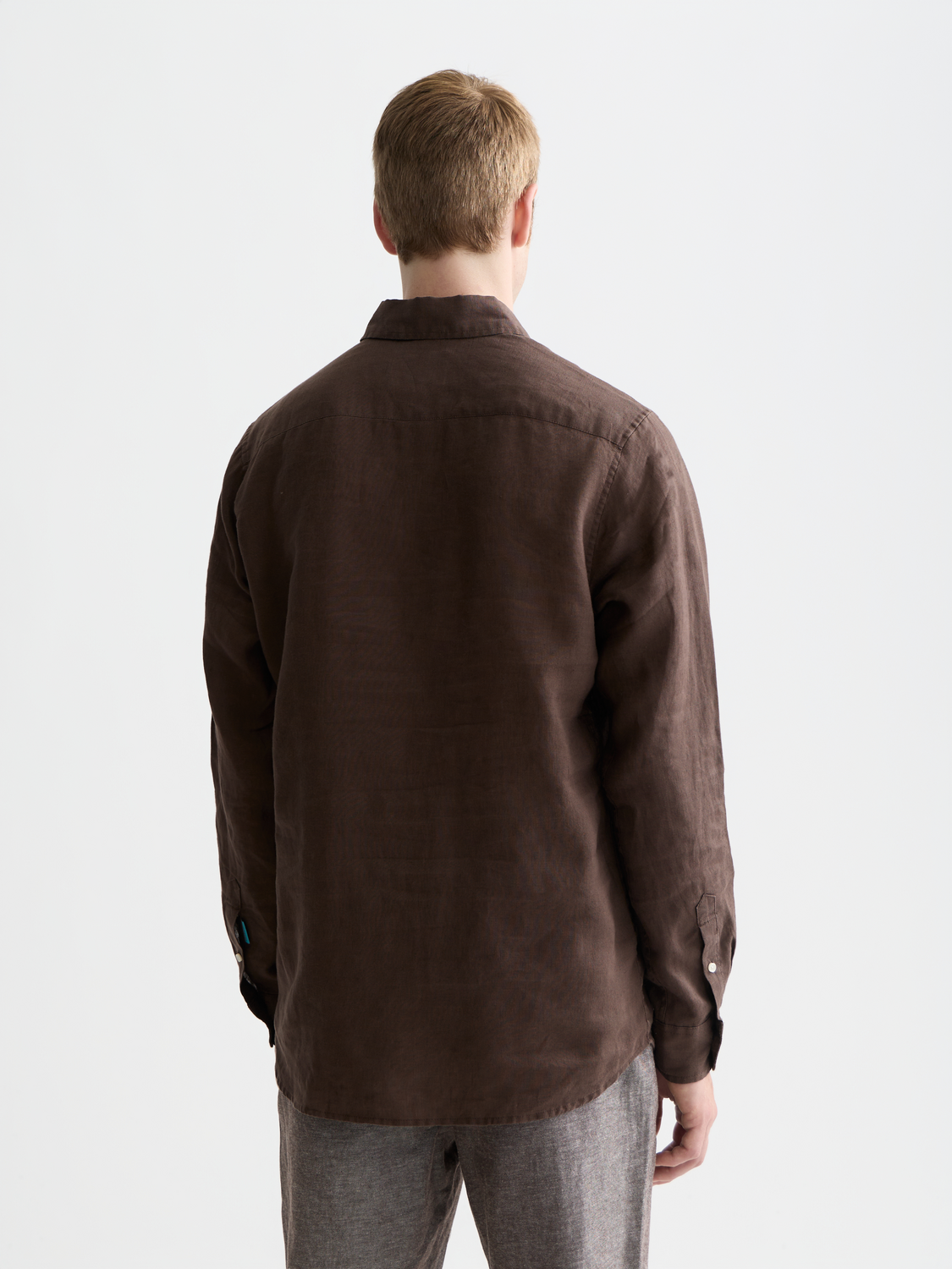 Long-sleeve linen shirt by Scotch & Soda, shown from the back, featuring a relaxed fit and natural fabric texture.