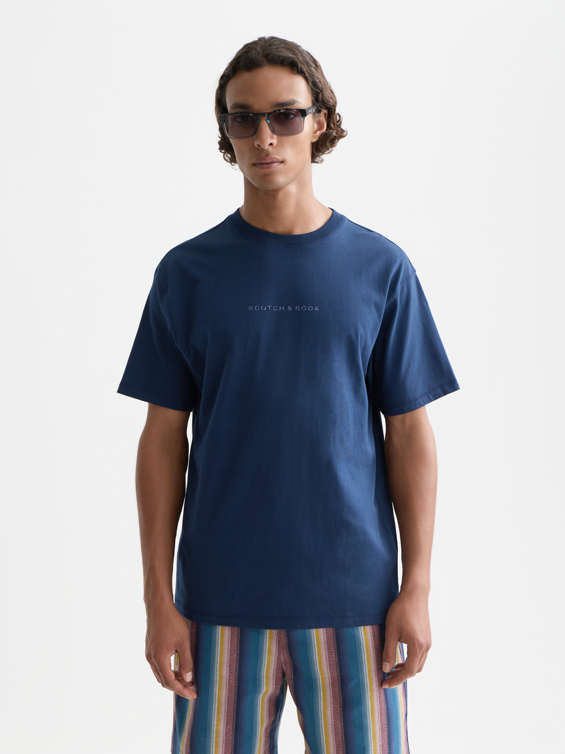 Scotch & Soda logo short sleeve t-shirt with graphic front design, casual fit, white fabric, and modern style.