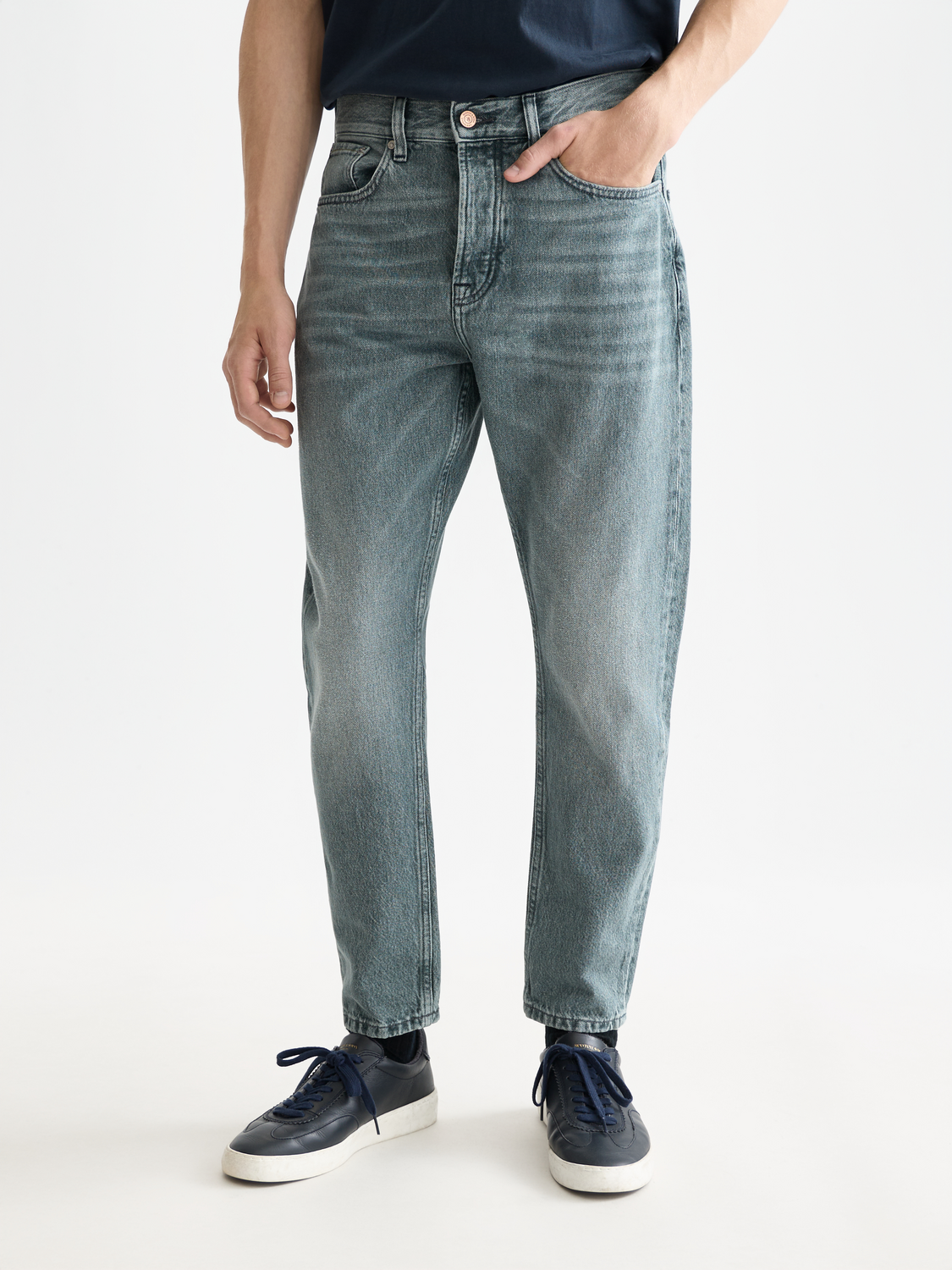 Scotch & Soda Dean tapered denim jeans showing a close-up of the front with classic five-pocket design and dark wash fabric.
