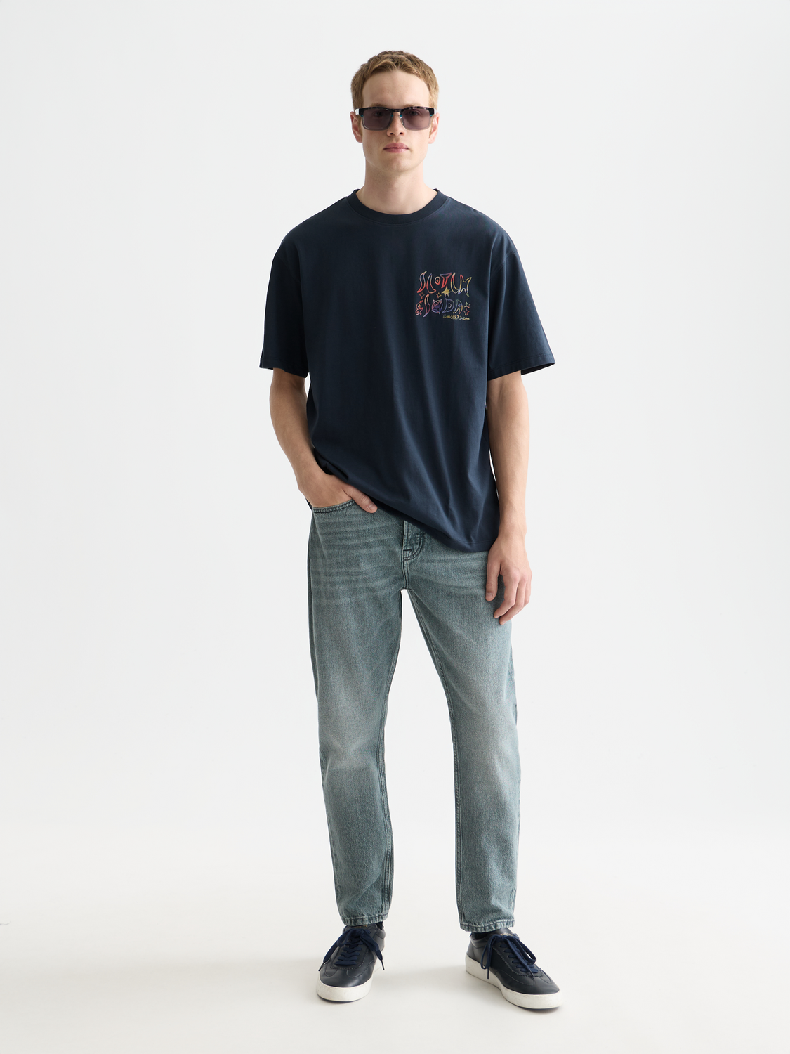 SCOTCH & SODA Dean tapered denim jeans showing a slim fit with classic five-pocket design and dark wash finish.