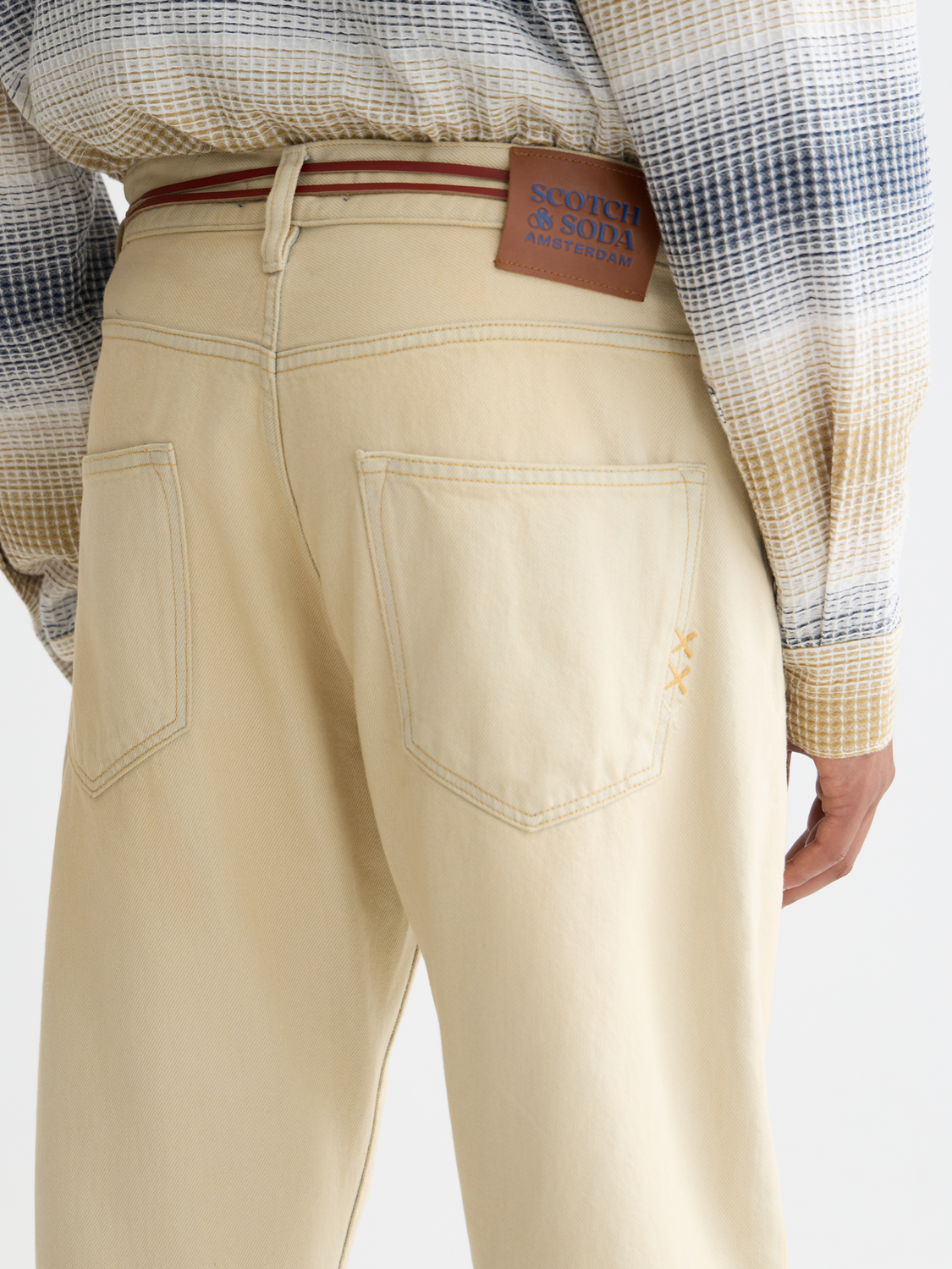 Scotch & Soda Dean tapered denim jeans showing slim fit design and classic blue wash with subtle fading and stitching details.