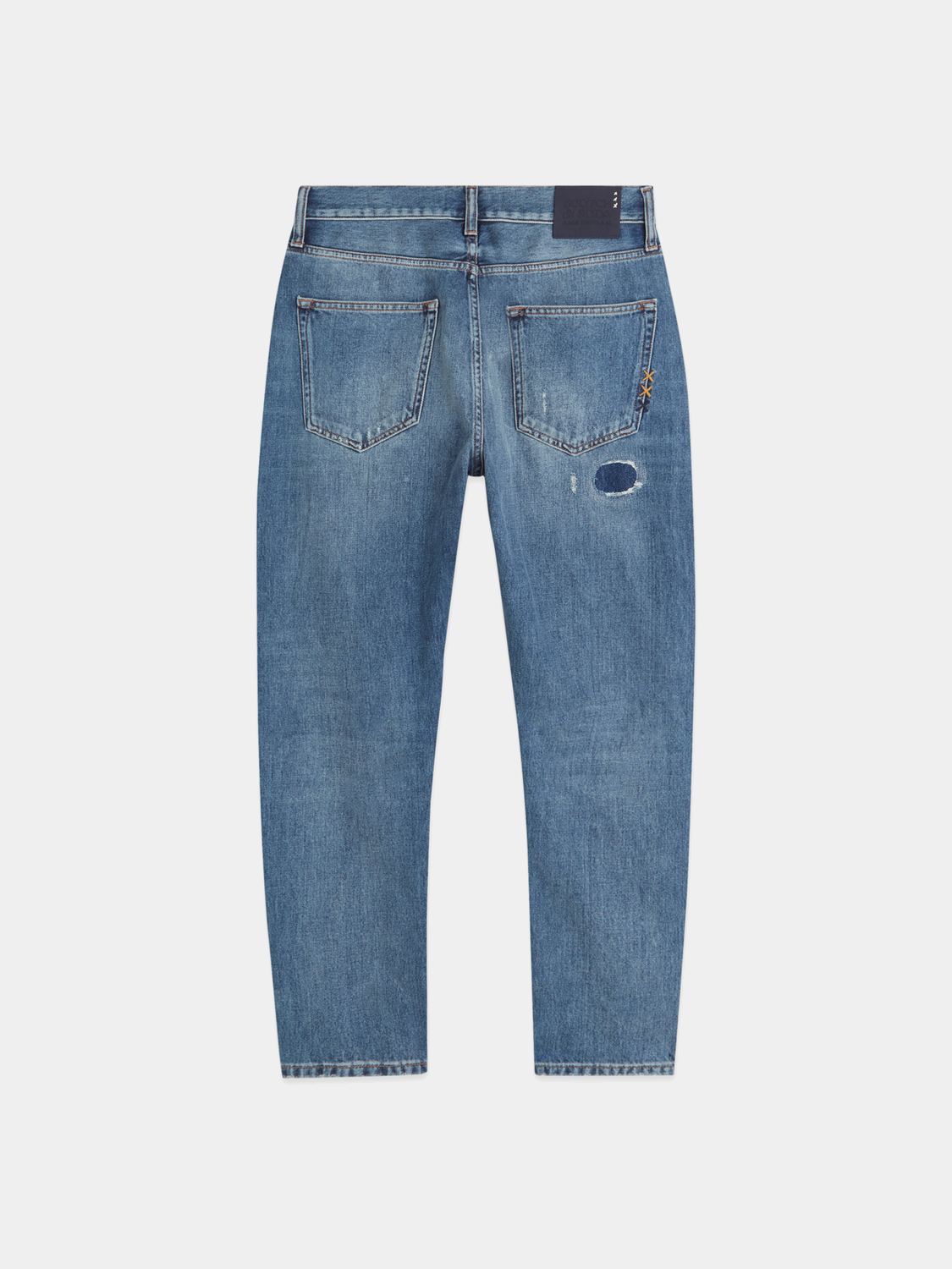 Dark blue Dean tapered denim jeans by Scotch & Soda, showing the fit and style of the casual denim pants.