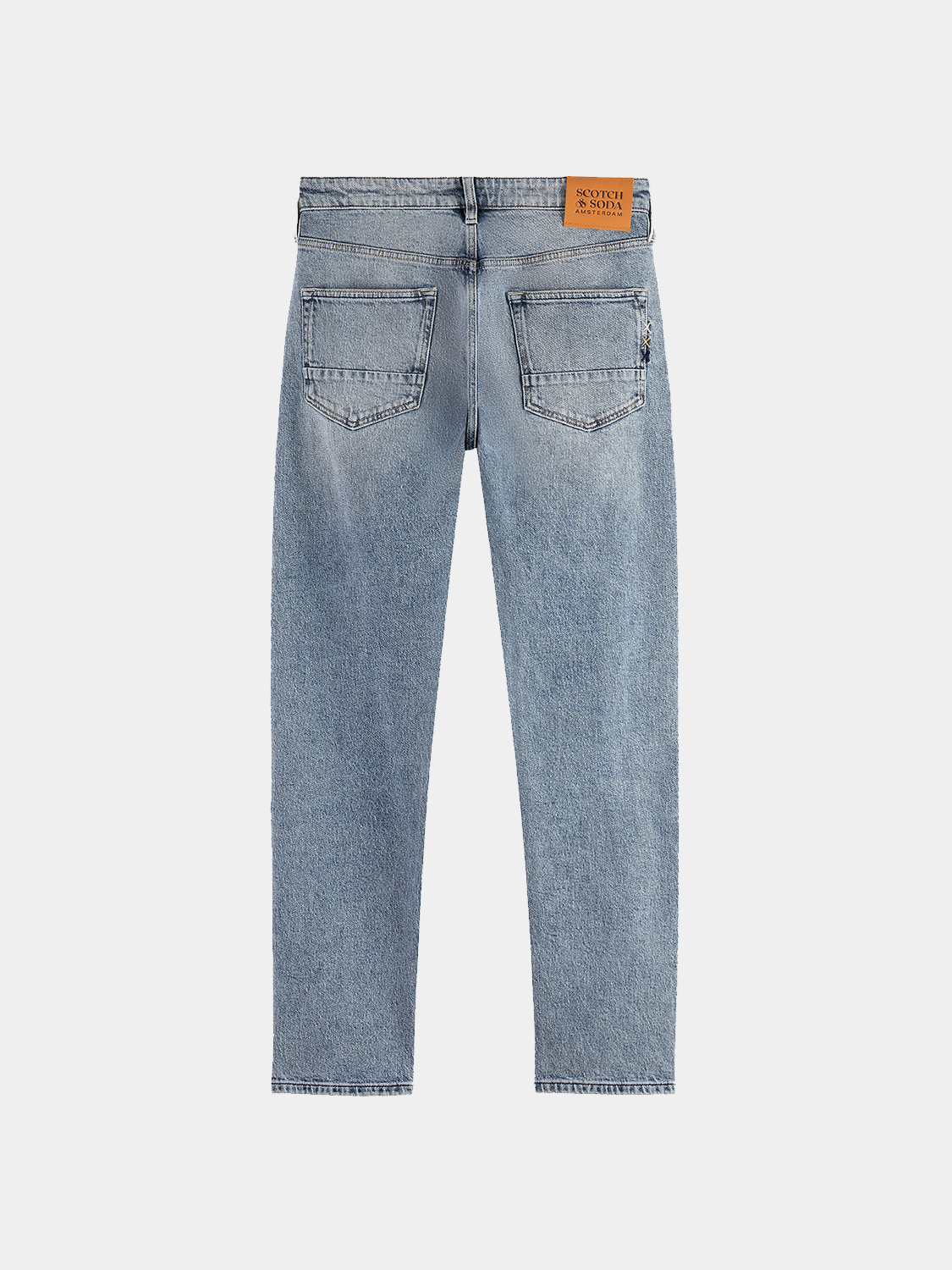 Dark blue Ralston slim-fit Scotch & Soda denim jeans with five-pocket design and contrast stitching, displayed on a hanger.