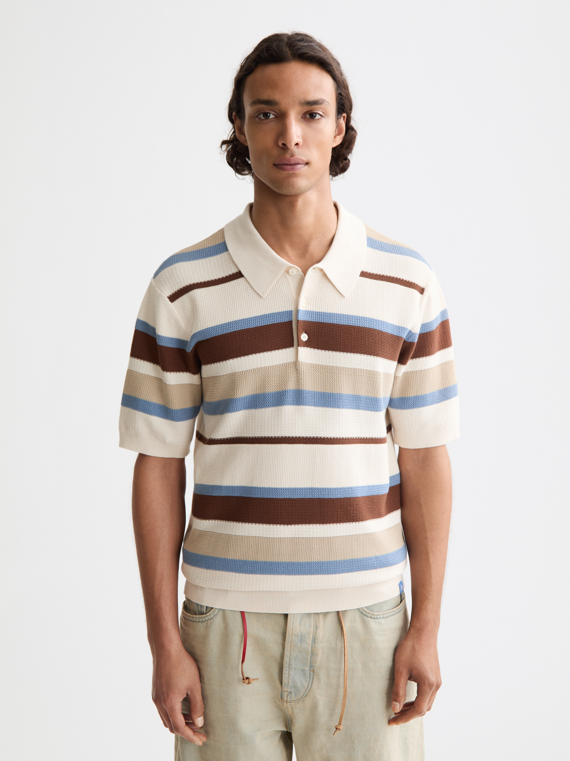Striped knitted polo shirt by Scotch & Soda featuring a classic collar and multicolor stripes.