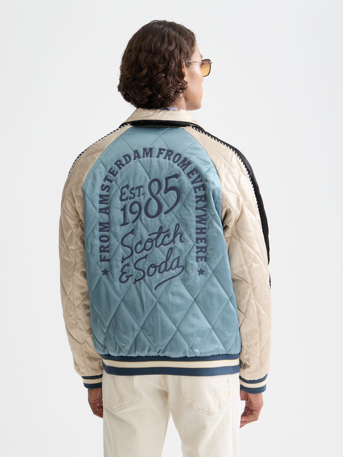 Reversible souvenir bomber jacket by Scotch & Soda, featuring vibrant patterns and a casual fit, front view.