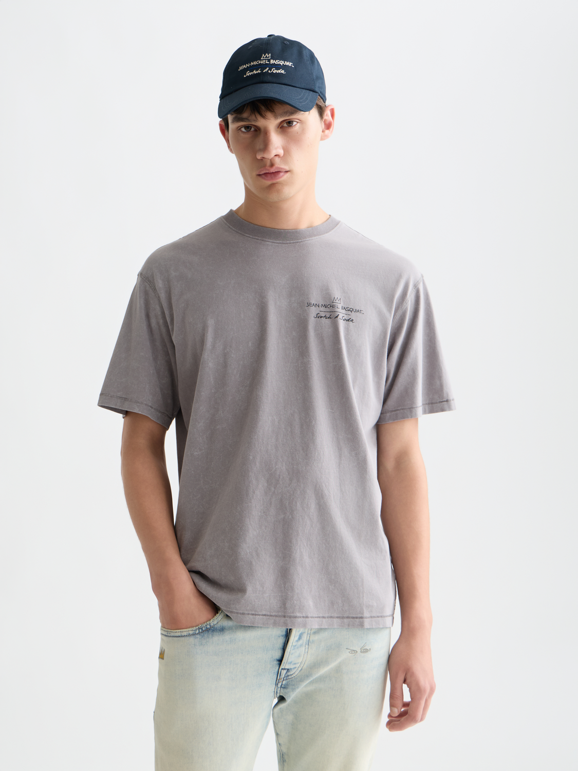 Short sleeve Scotch & SODA t-shirt featuring a vibrant S&S x Basquiat artwork design on the front.