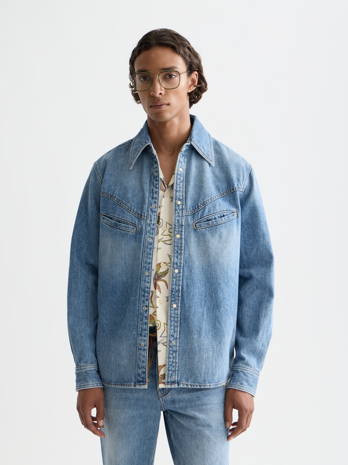 Washed denim long sleeve shirt by Scotch & Soda featuring classic collar and button front, displayed on a hanger.
