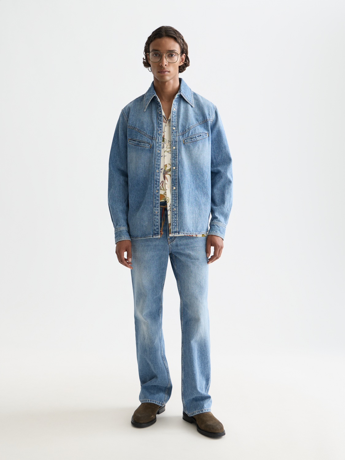 Long sleeve washed denim shirt by Scotch & Soda, shown on a hanger with a casual fit and classic denim texture.