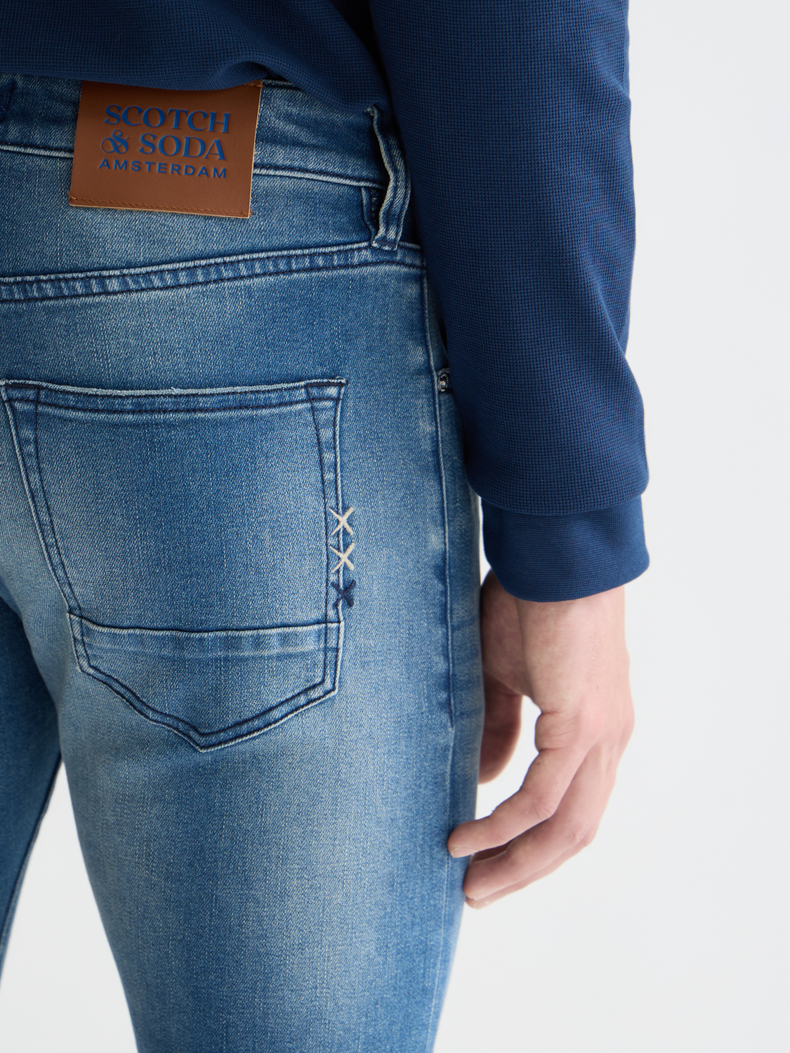 Slim-fit denim jeans by Scotch & Soda featuring classic five-pocket design and a dark wash.