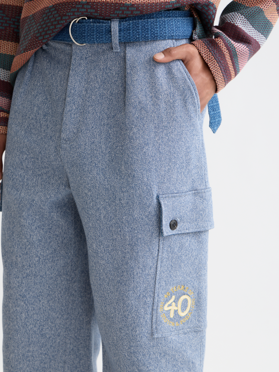 Loose straight-fit cargo pants by Scotch & Soda, shown in a neutral color, with multiple pockets and relaxed fit.