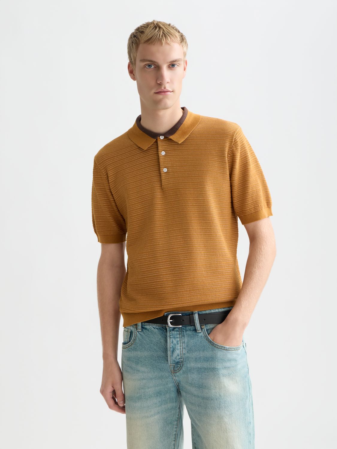 Scotch & Soda knitted polo shirt with a classic collar and textured fabric, displayed on a neutral background.