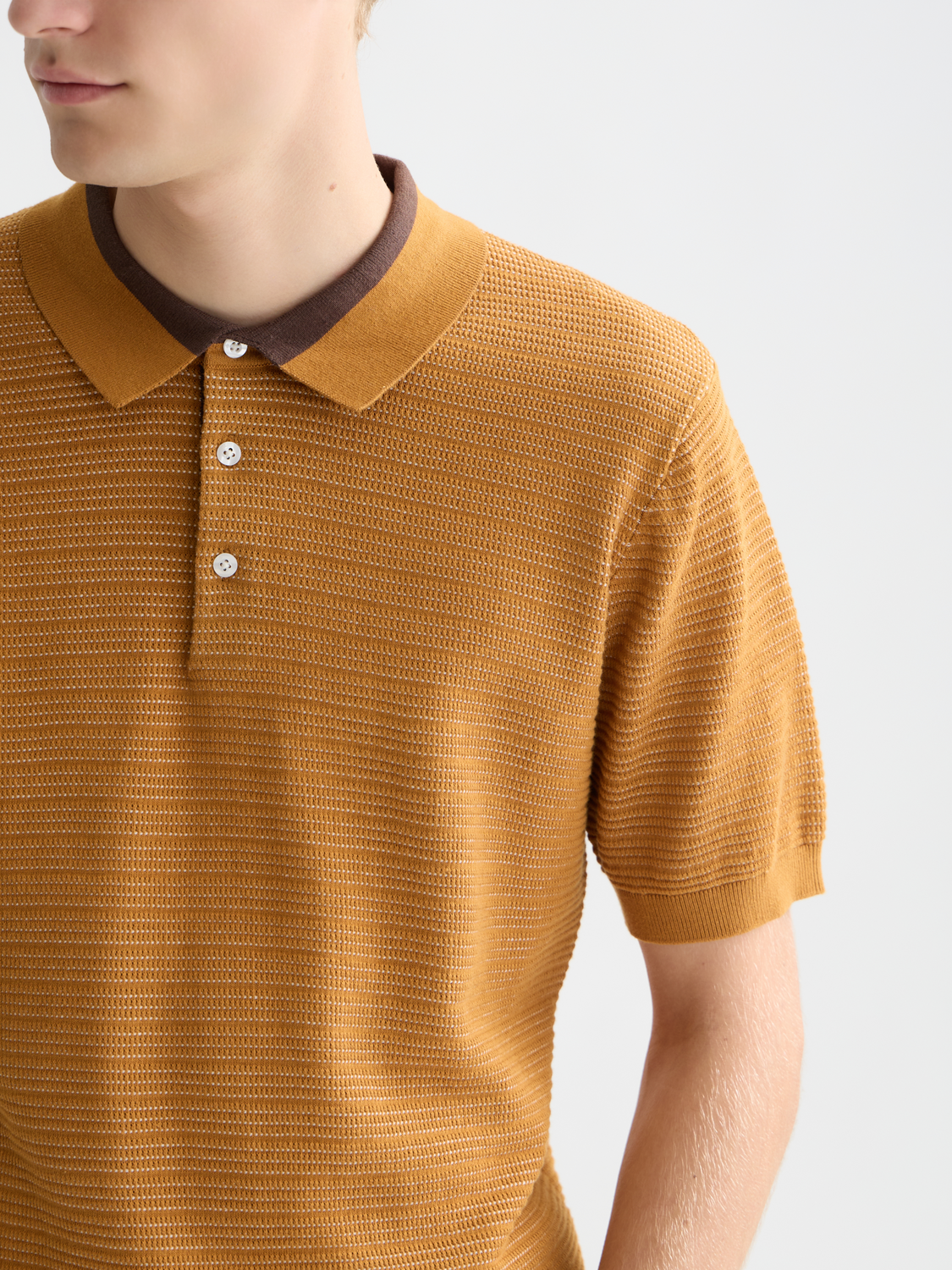 Blue knitted polo shirt by Scotch & Soda with a classic collar and textured knit pattern.