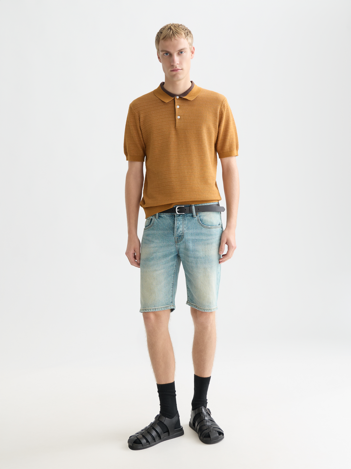 Close-up of a beige knitted polo shirt by Scotch & Soda, featuring a textured knit pattern and classic collar.