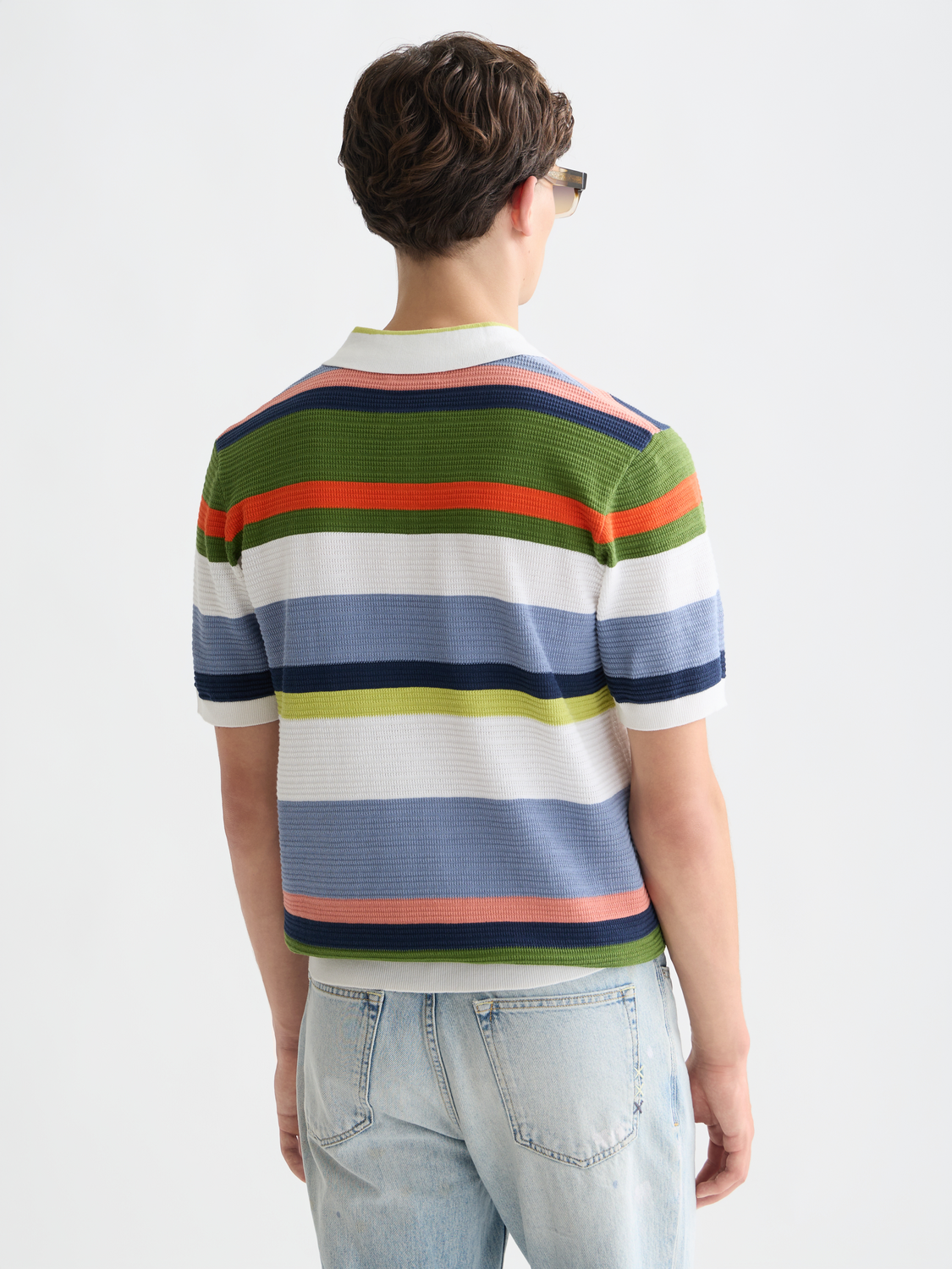 Knitted striped polo shirt by Scotch & Soda, featuring a classic collar and bold stripe pattern, shown from the back.
