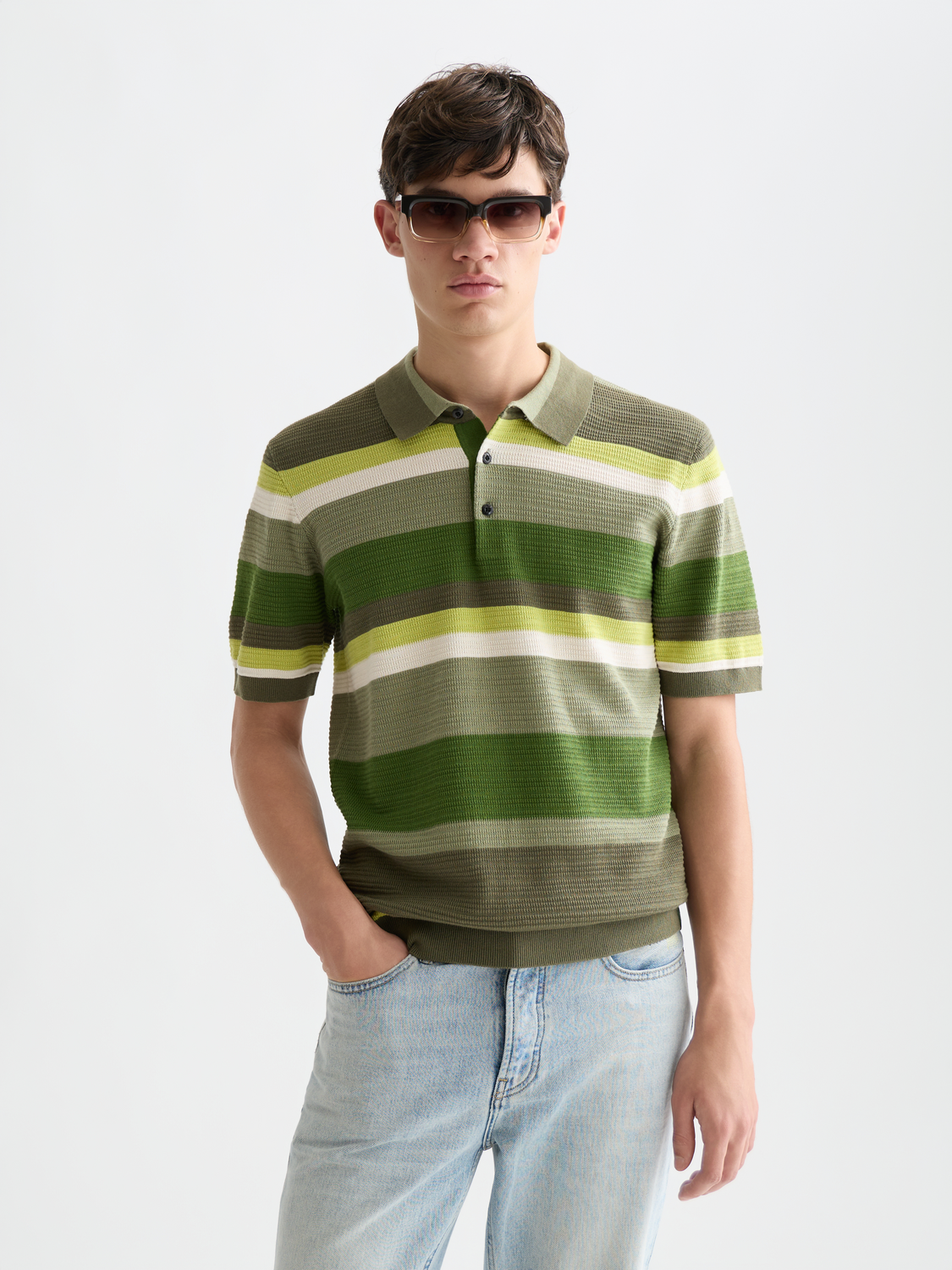 Knitted striped polo shirt from Scotch & Soda featuring a classic collar and multicolor pattern on the front.