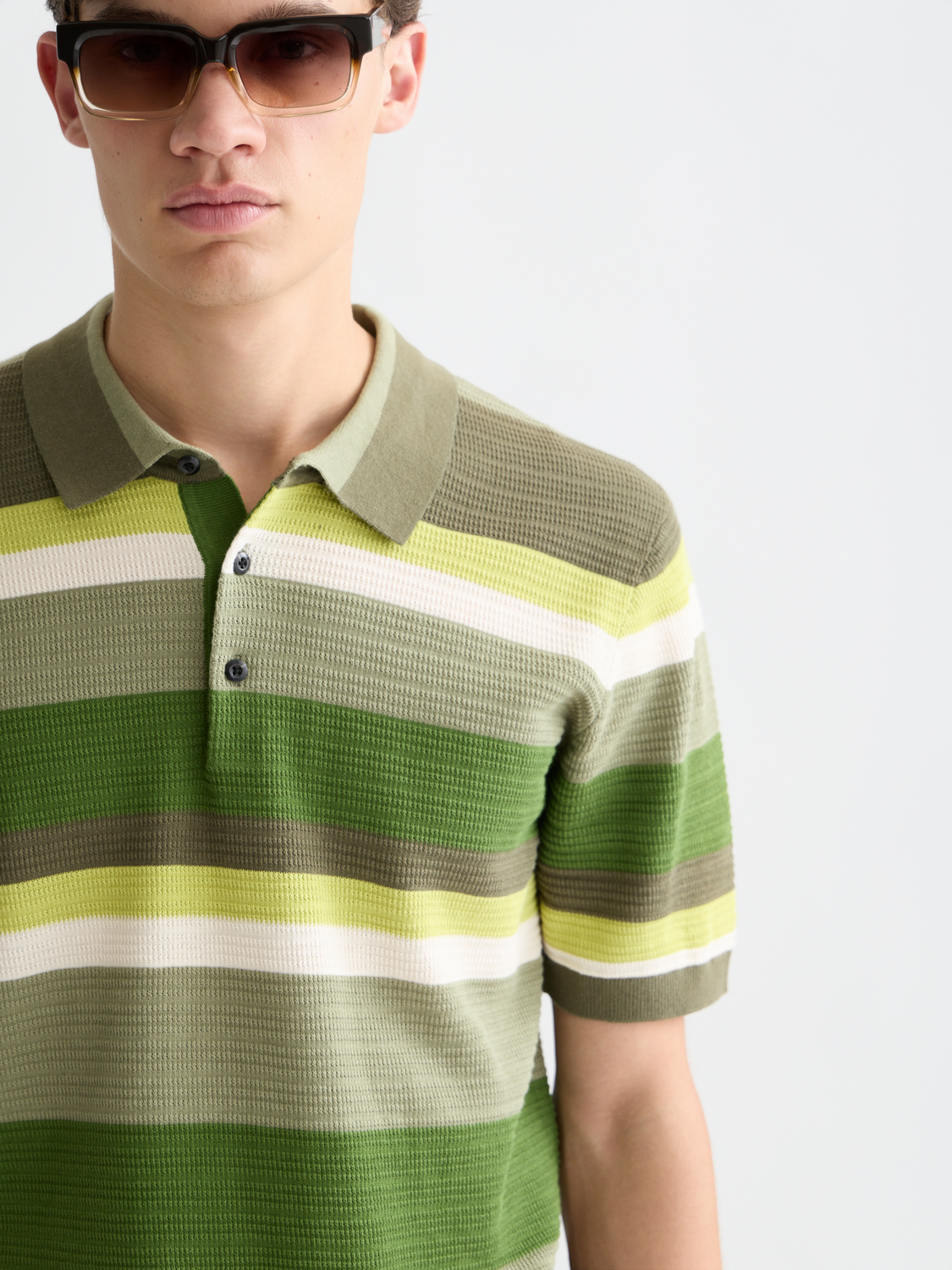 Knitted striped polo shirt by Scotch & Soda featuring a classic collar and multicolor stripes for a stylish casual look.