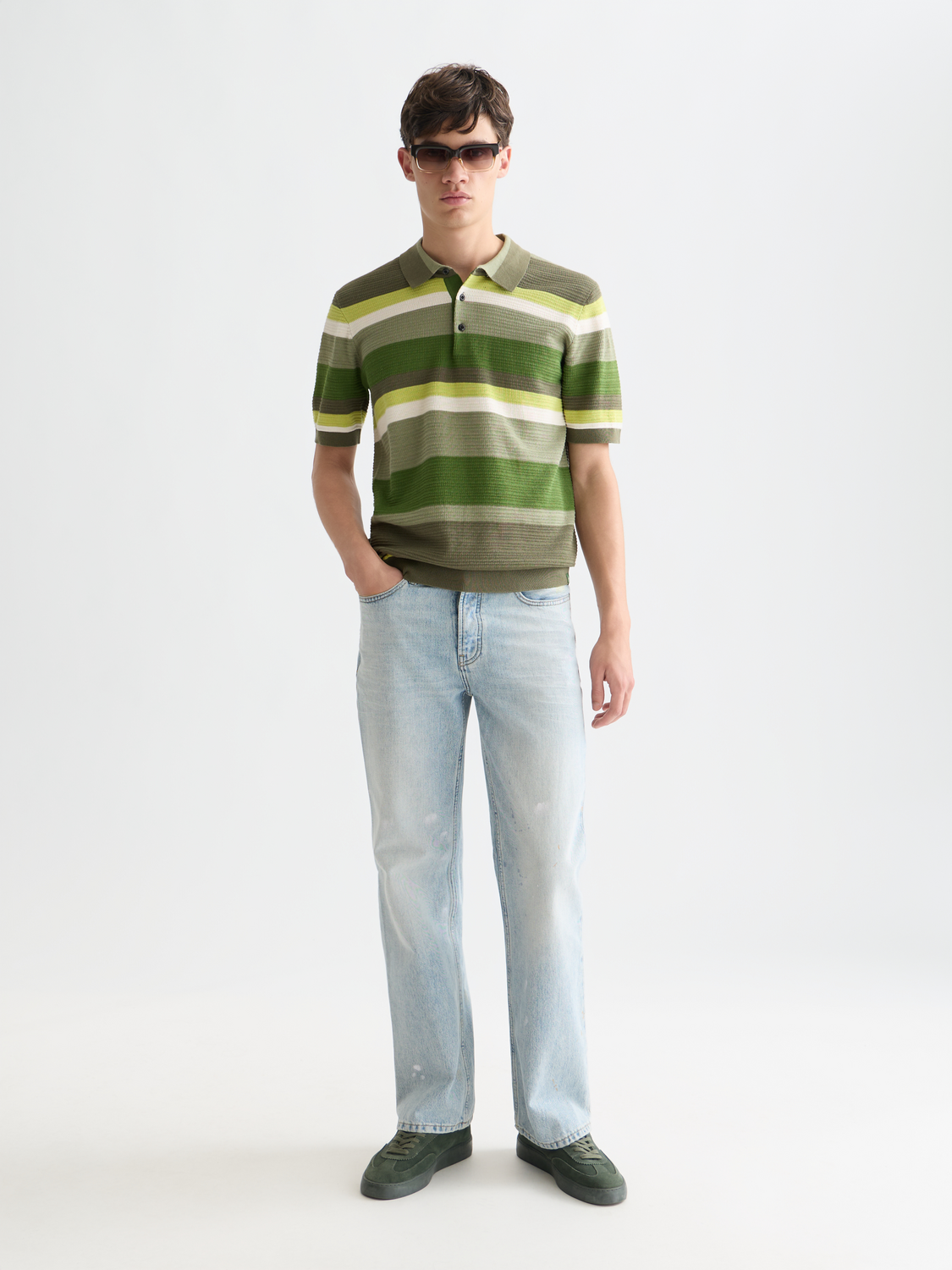 Knitted striped polo shirt from Scotch & Soda featuring a classic collar and colorful horizontal stripes.