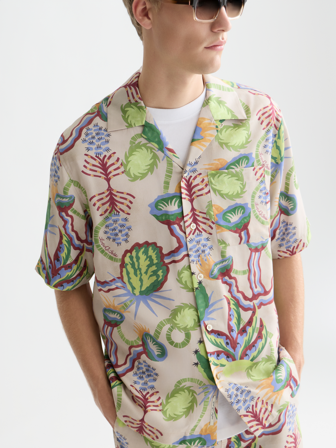Printed short-sleeved shirt from Scotch & Soda with vibrant pattern, lightweight fabric, and casual fit displayed in the image.