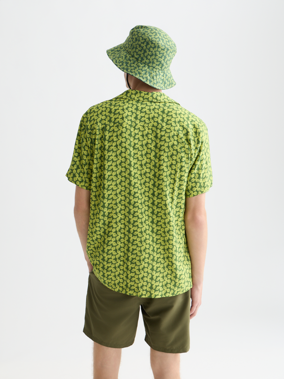 Printed Scotch & Soda short-sleeved shirt with colorful pattern, casual style, and button-up front, shown from the back.