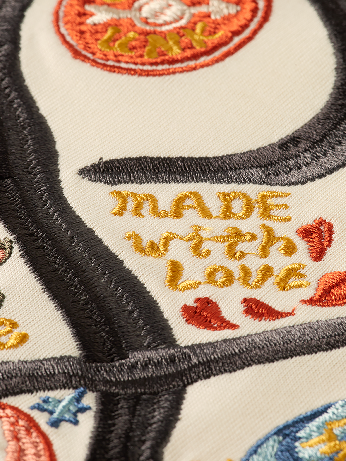 Embroidered SCOTCH & SODA short-sleeve T-shirt with colorful floral embroidery on light fabric.
