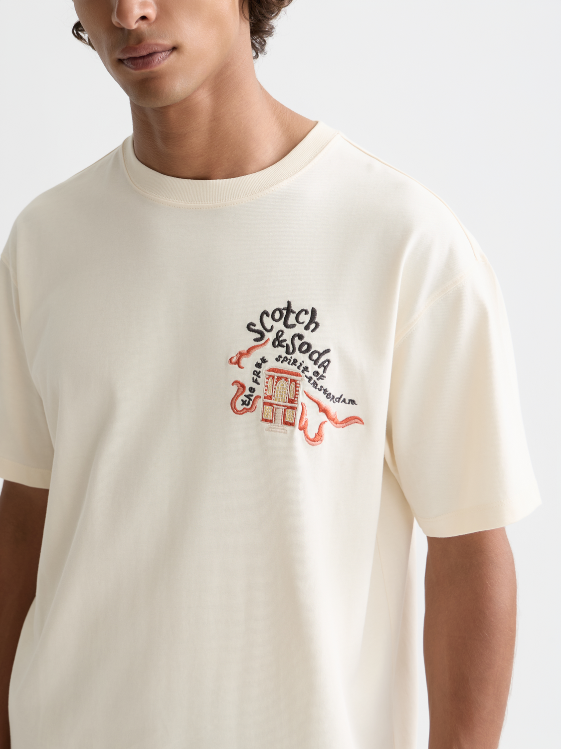 Light blue embroidered SCOTCH & SODA short-sleeve t-shirt with colorful floral embroidery on front.