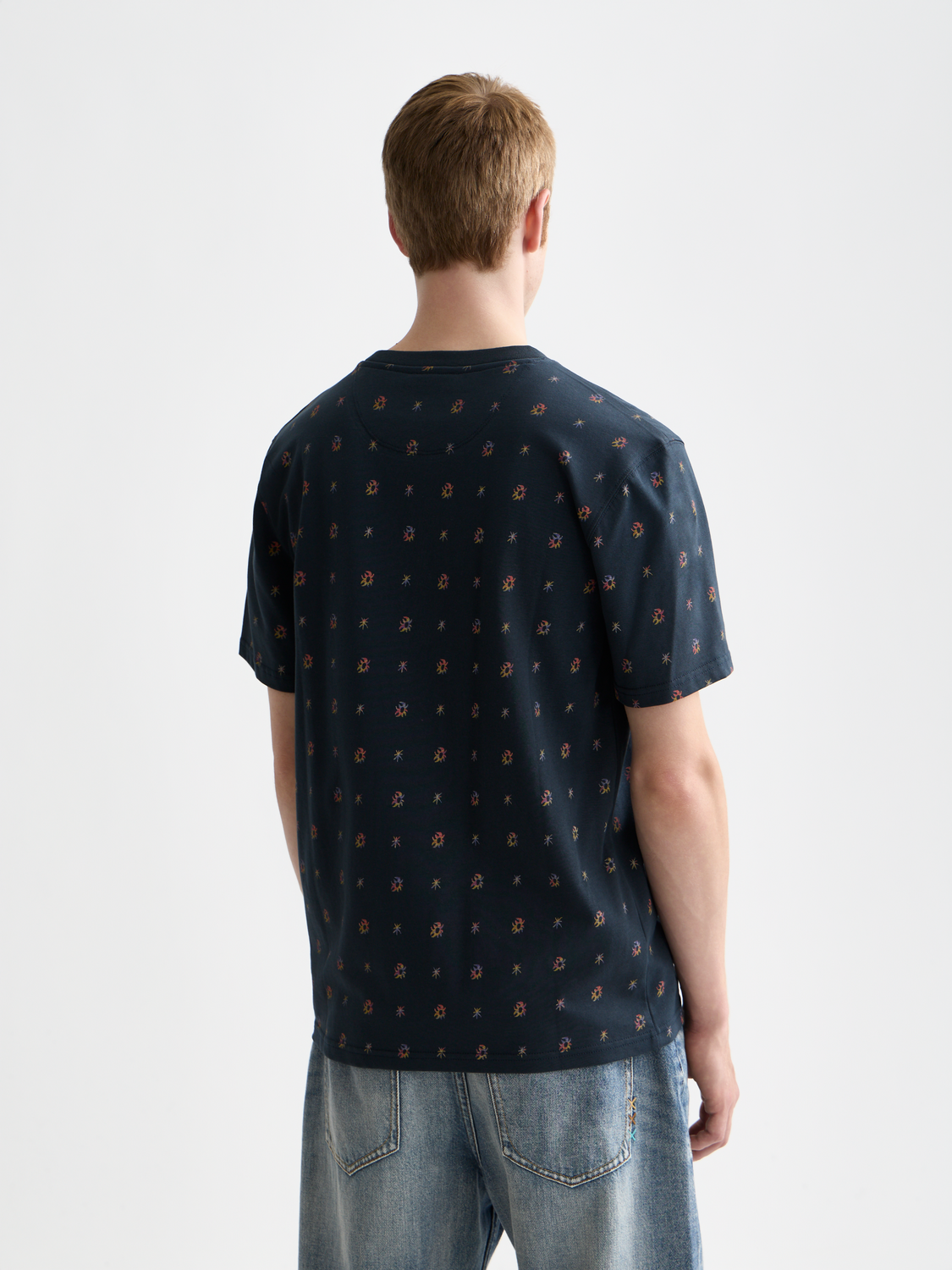 Printed Scotch & Soda short sleeve t-shirt with colorful graphic design on front, casual style, black background.