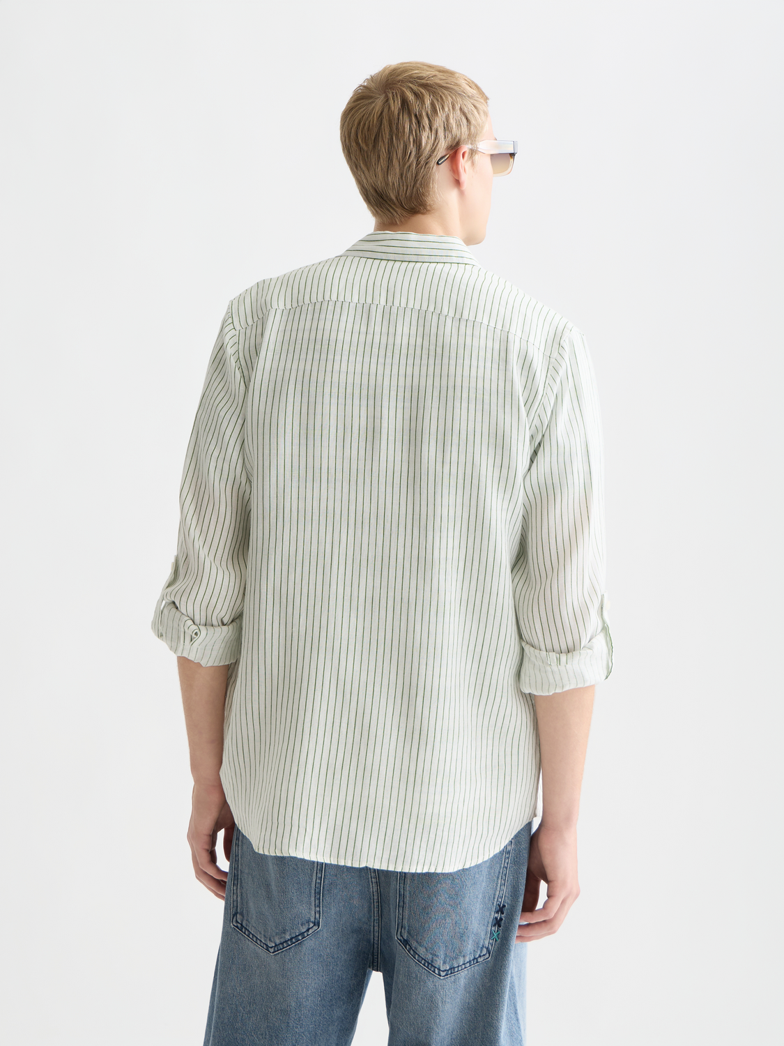 Striped linen long sleeve shirt by Scotch & Soda with blue and white vertical stripes, shown from the back.