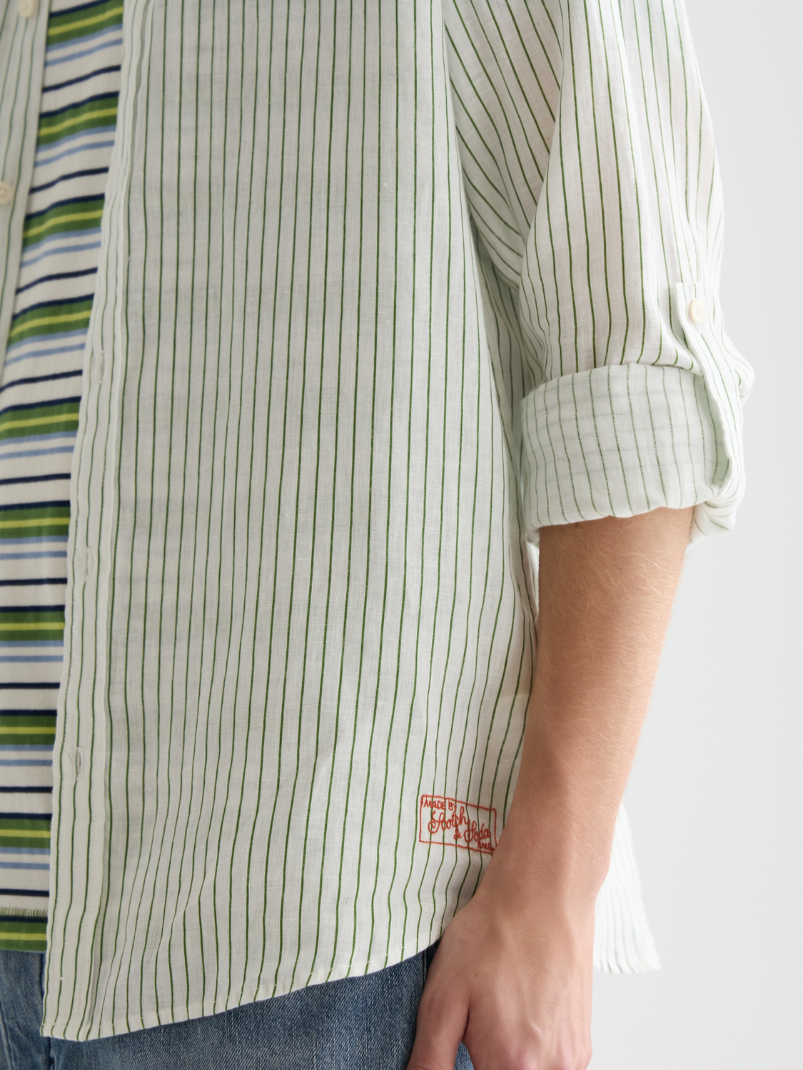 Striped linen long sleeve shirt by Scotch & Soda, featuring a casual fit and classic pattern, displayed on a hanger.