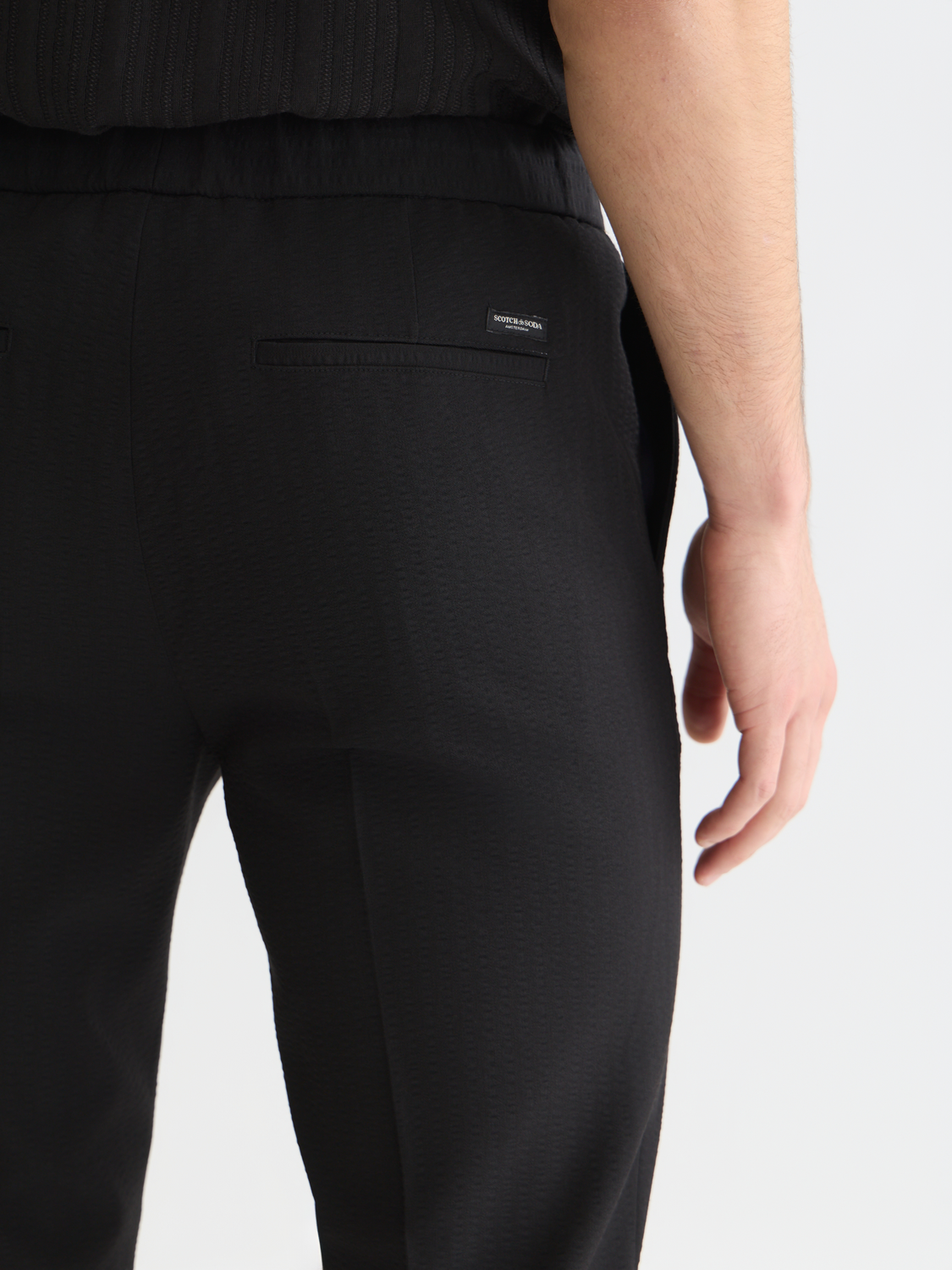 Dark blue Scotch & Soda Finch tapered-fit pants with front pockets and belt loops, shown on a neutral background.
