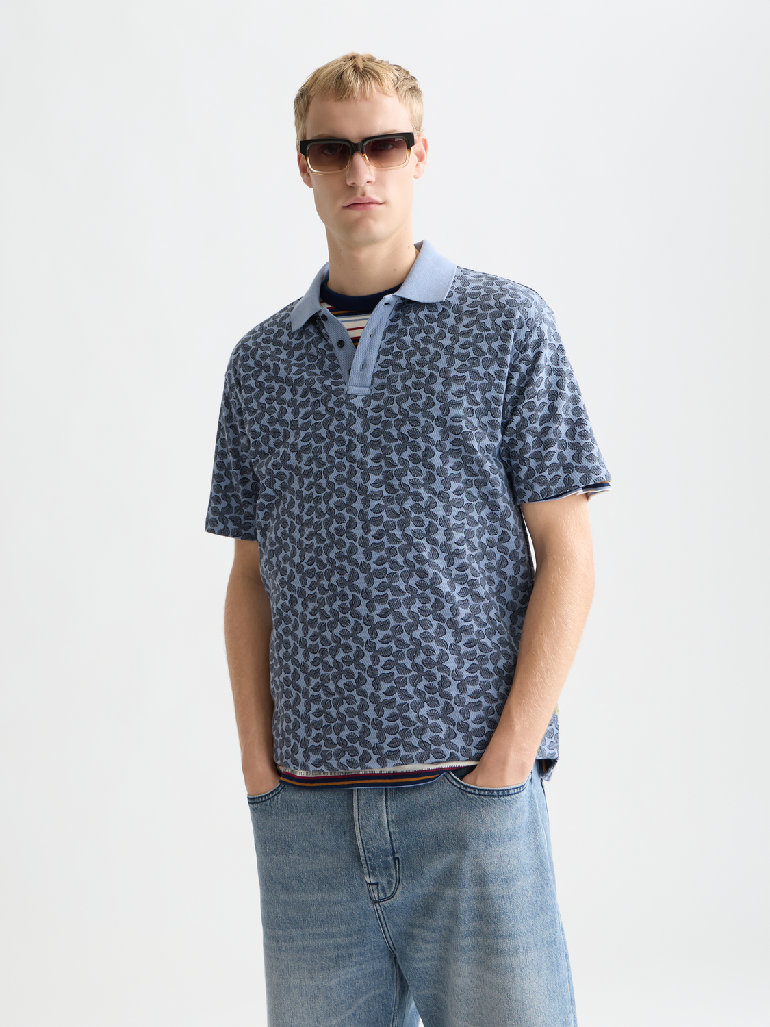 Printed SCOTCH & SODA polo shirt with colorful pattern, short sleeves, and classic collar, displayed on a plain background.