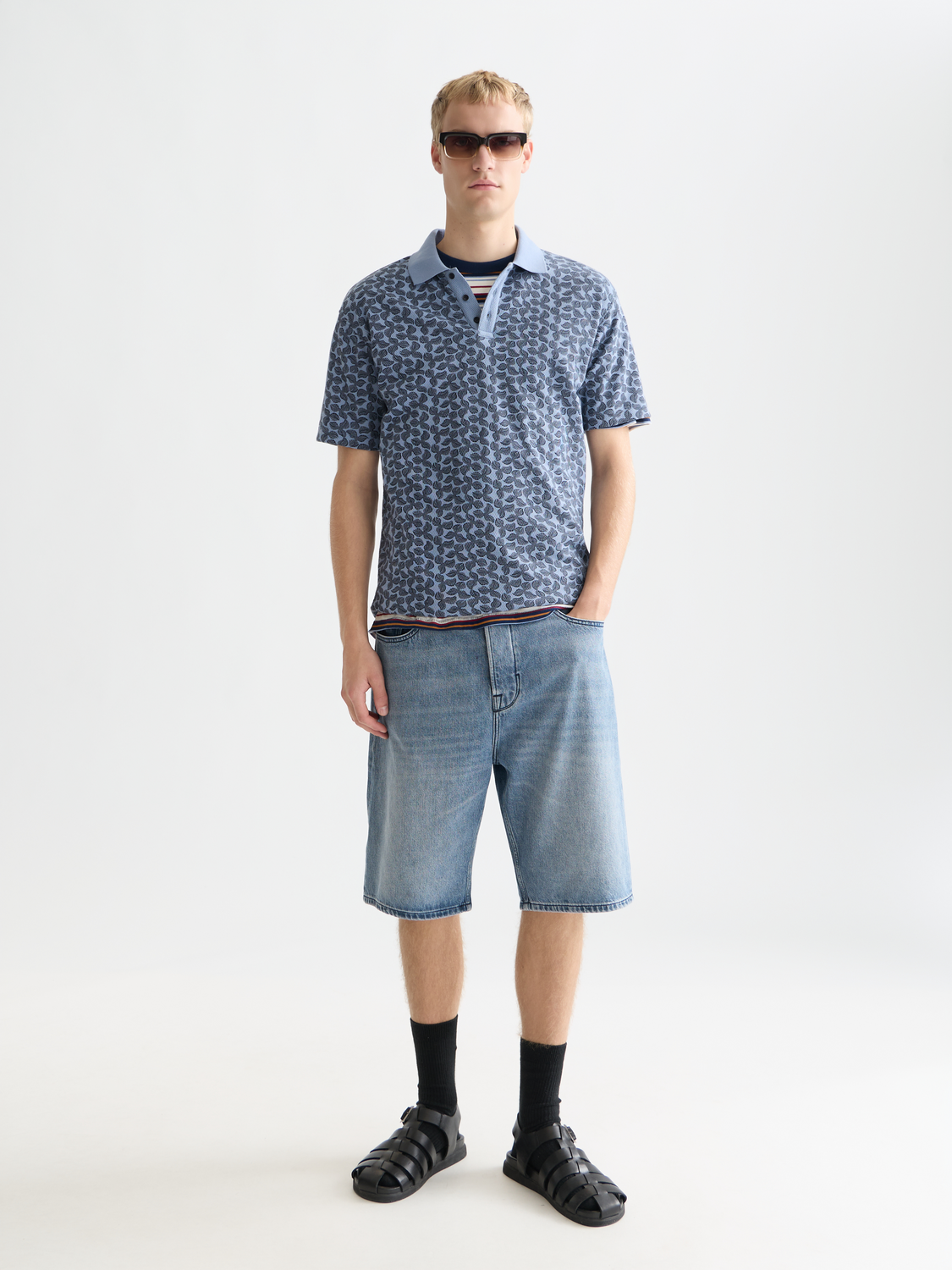Printed Scotch & Soda polo shirt with colorful pattern, classic collar, and short sleeves, displayed on a hanger.