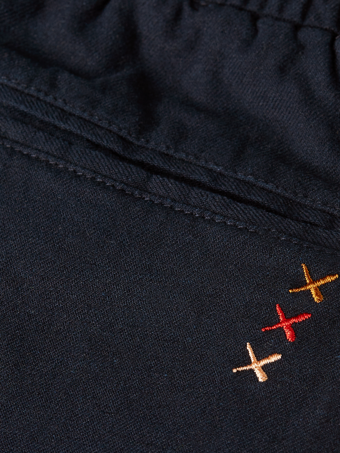 Kids cargo shorts by Scotch & Soda, featuring multiple pockets and a comfortable fit, shown on a child in casual outdoor wear.