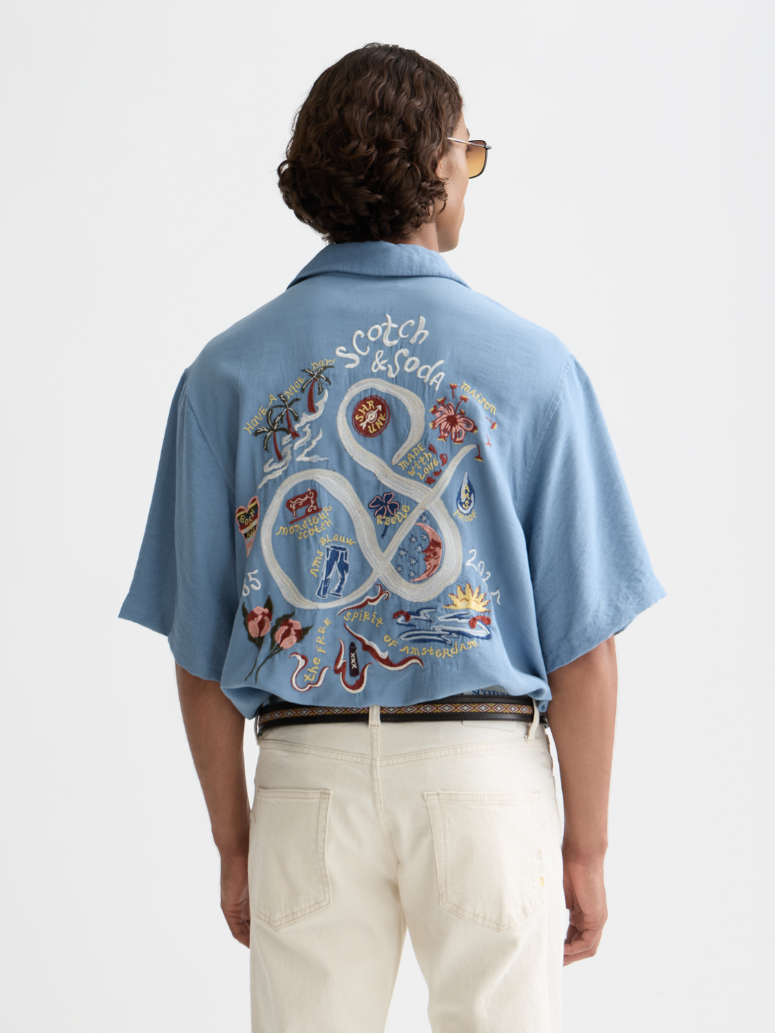 Blue embroidered Scotch & Soda short-sleeve shirt with floral patterns and button front, casual summer style.