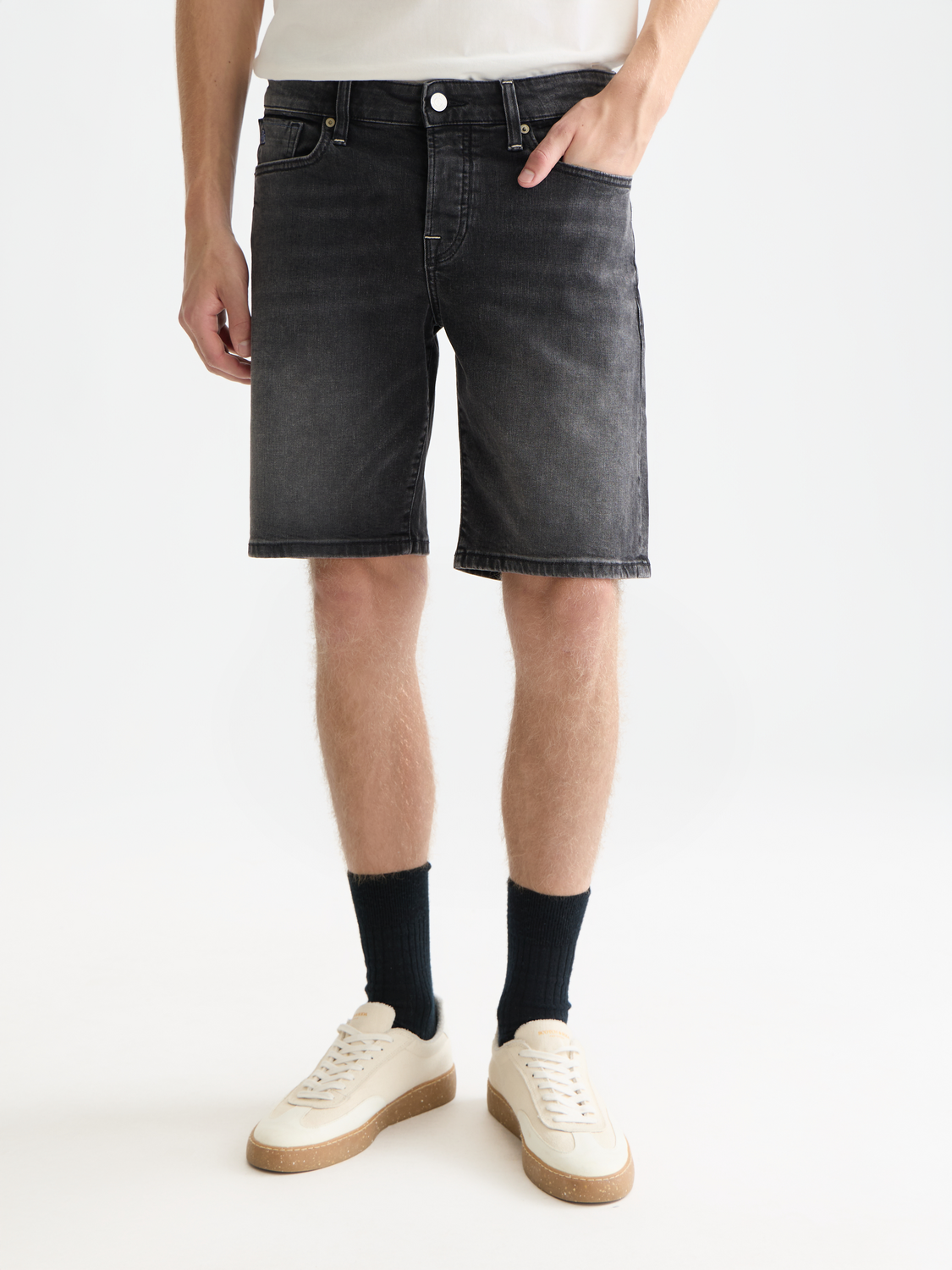 Scotch & Soda Ralston denim shorts with distressed details and frayed hem, styled on a mannequin.