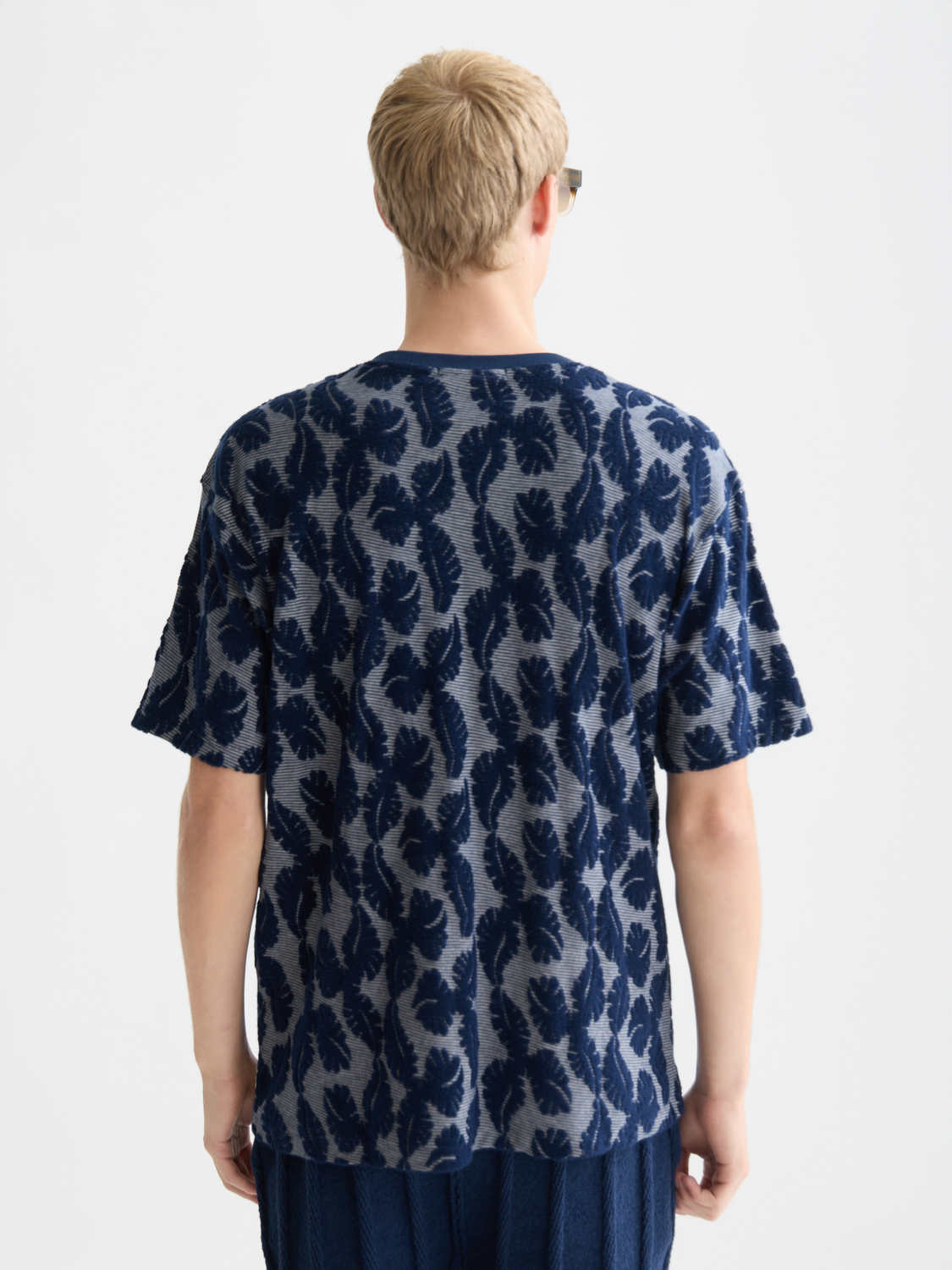 Blue and white striped Scotch & Soda short-sleeve Jacquard t-shirt displayed from the back, showcasing the textured fabric and fit.