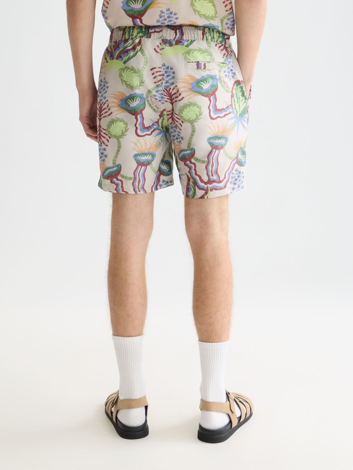 Printed SCOTCH & SODA swimshorts with a colorful pattern, back view showing the waistband and vibrant design.