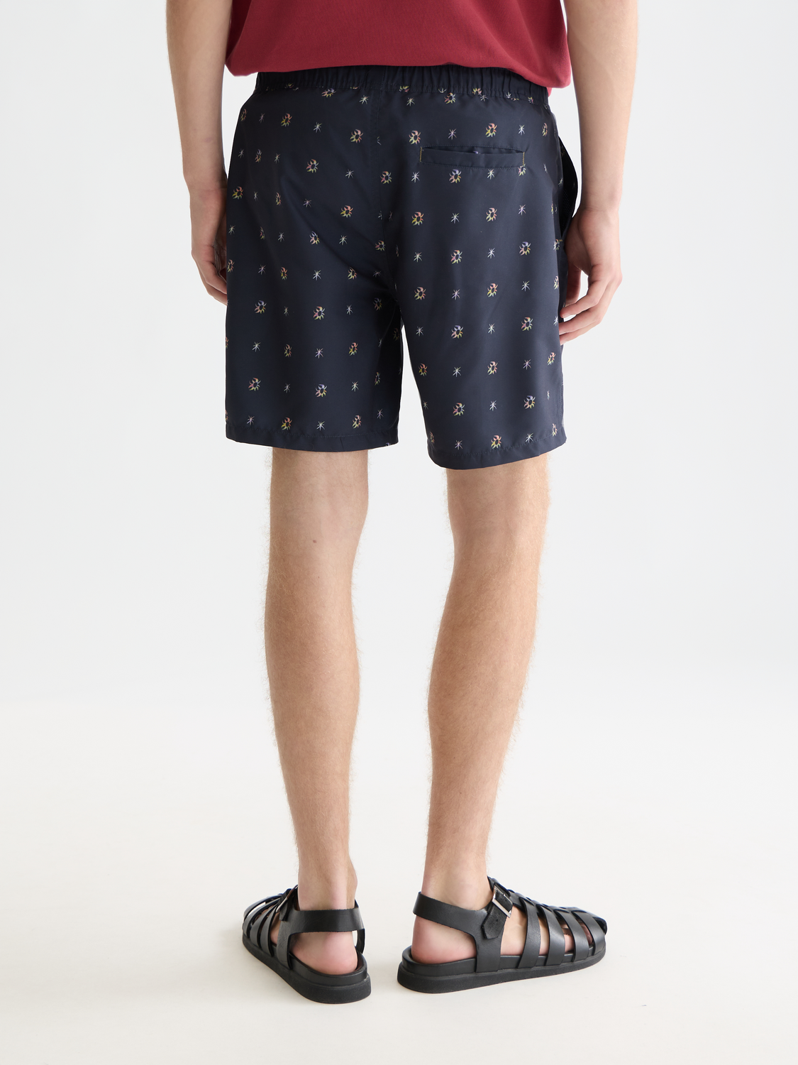 Printed SCOTCH & SODA swimshorts with vibrant patterns, shown from the back in this image. Ideal for beach or poolside wear.