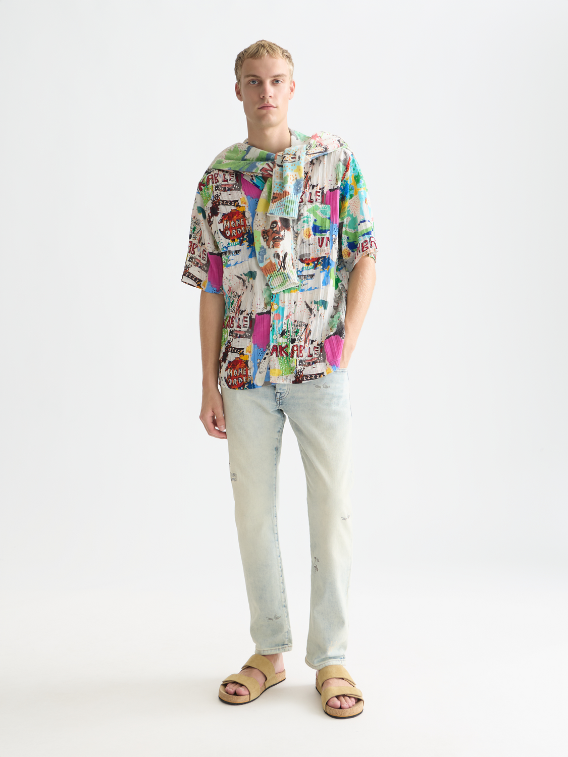 Short-sleeved shirt by Scotch & Soda featuring S&S x Basquiat print, with colorful abstract artwork on fabric.