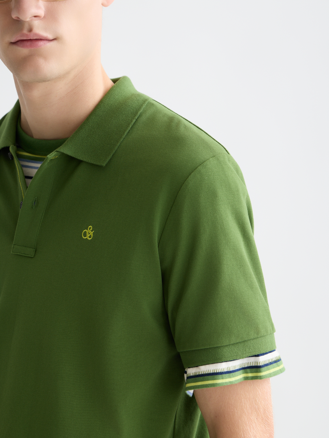 Scotch & Soda logo pique polo shirt in navy, with classic collar and short sleeves, displayed on a hanger.