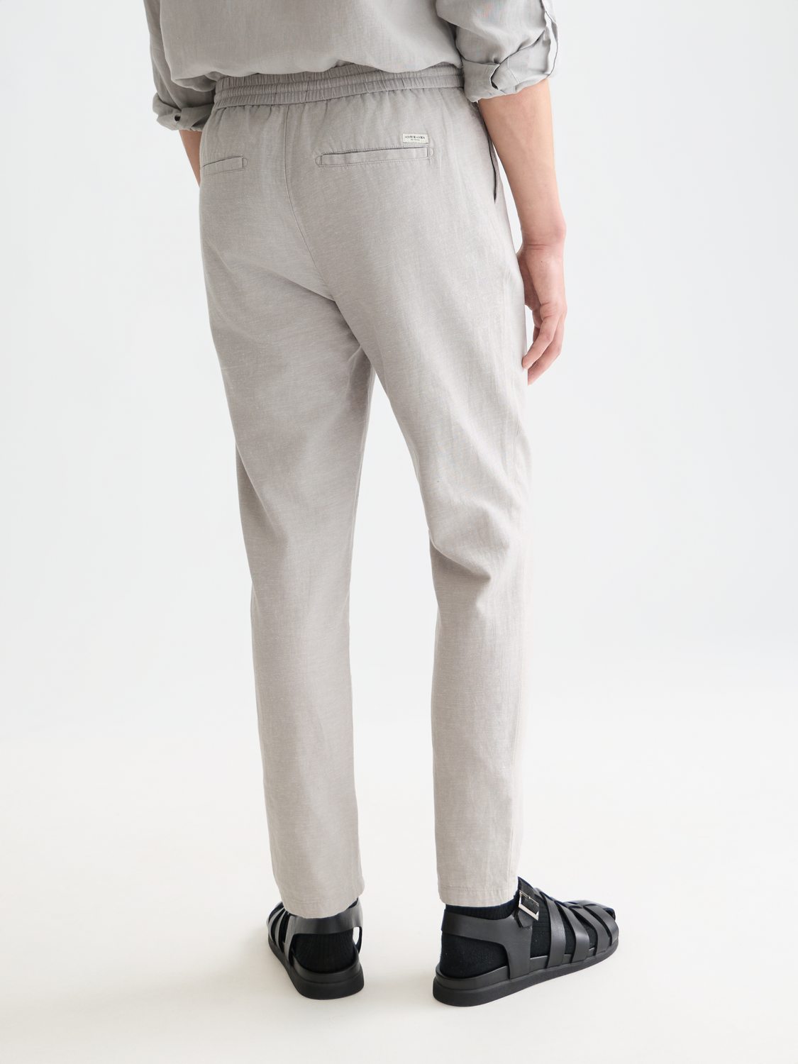 SCOTCH & SODA Warren joggers pants shown from the back, featuring a relaxed fit and casual style in a neutral color.