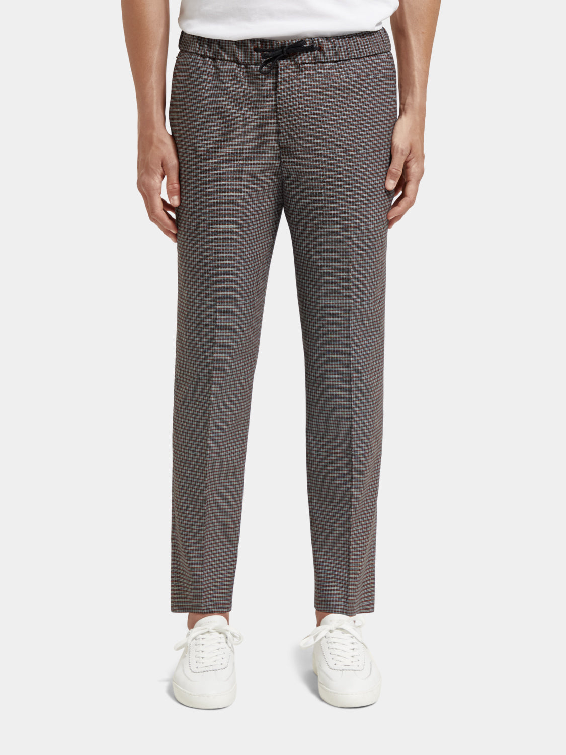 Scotch & Soda Finch tapered fit pants in dark fabric with a slim silhouette, shown on a model.