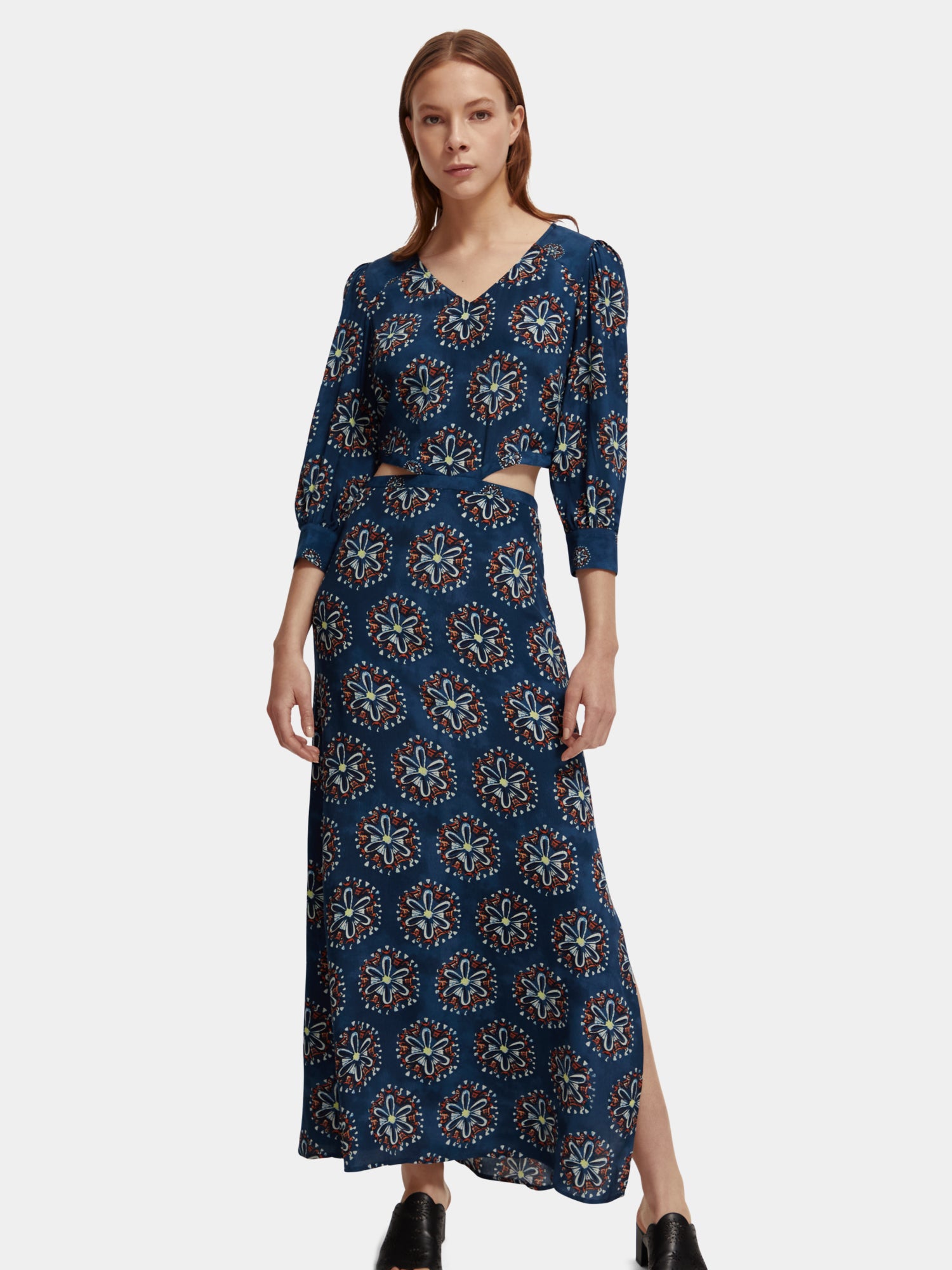 Scotch & Soda cut-out maxi dress with flowing fabric and stylish design, showcased on a model in a bright, modern setting.