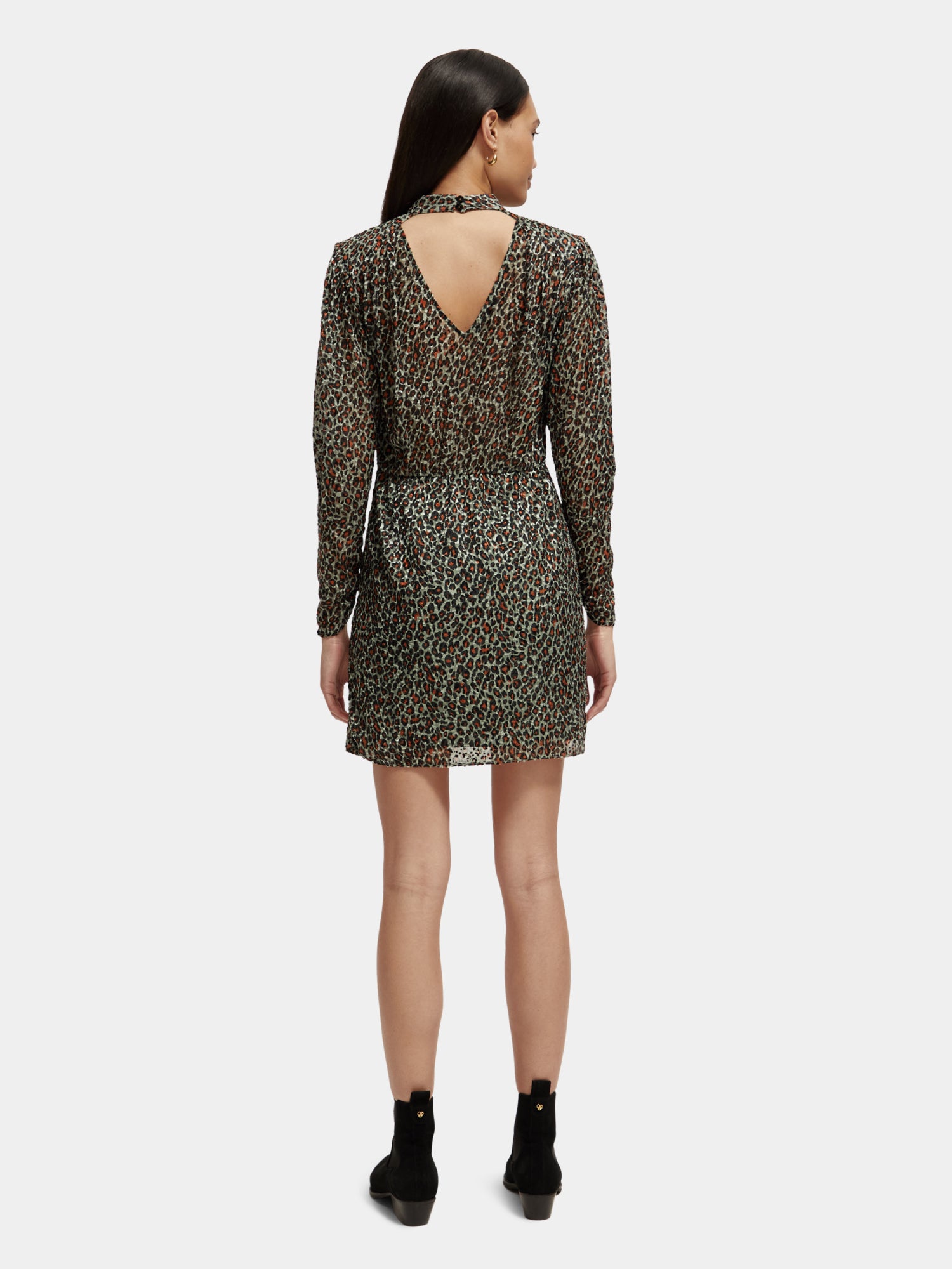 Black mock neck mini dress by Scotch & Soda, shown from the back with fitted silhouette and mini length.