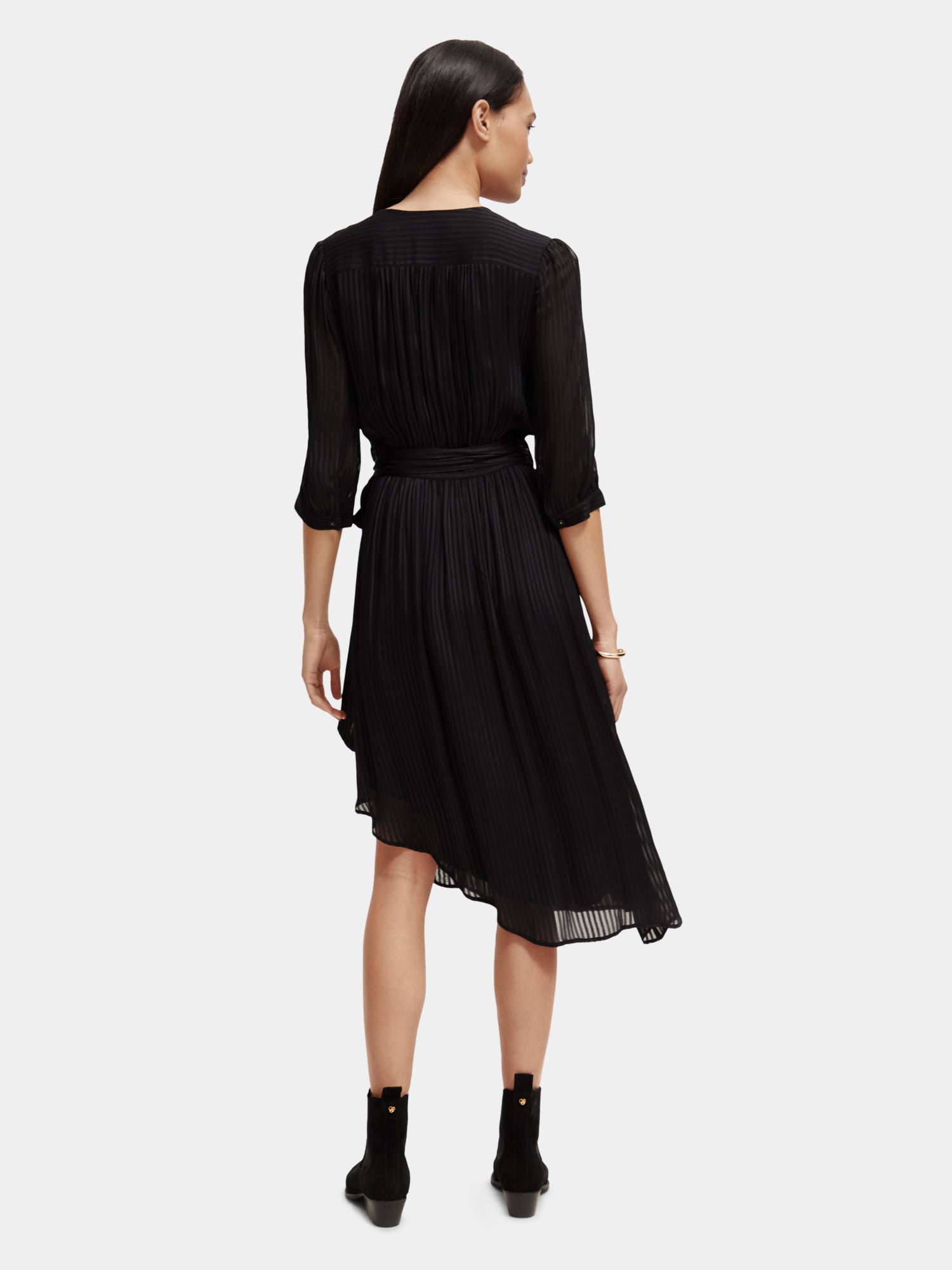 Black V-neck midi dress by Scotch & Soda featuring a fitted waist and flowing skirt, perfect for elegant daytime wear.