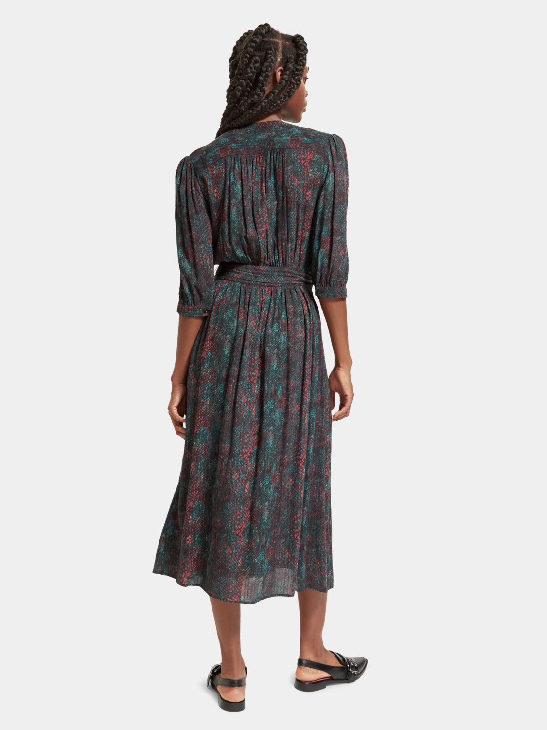 Scotch & Soda midi wrap dress displayed from the back, featuring a stylish design with a fitted waist and flowing fabric.