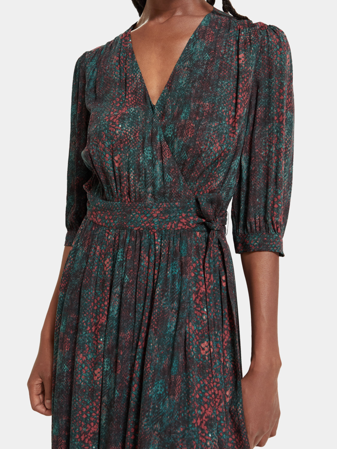 SCOTCH & SODA midi wrap dress with floral pattern, featuring long sleeves and a tie waist, displayed on a mannequin.